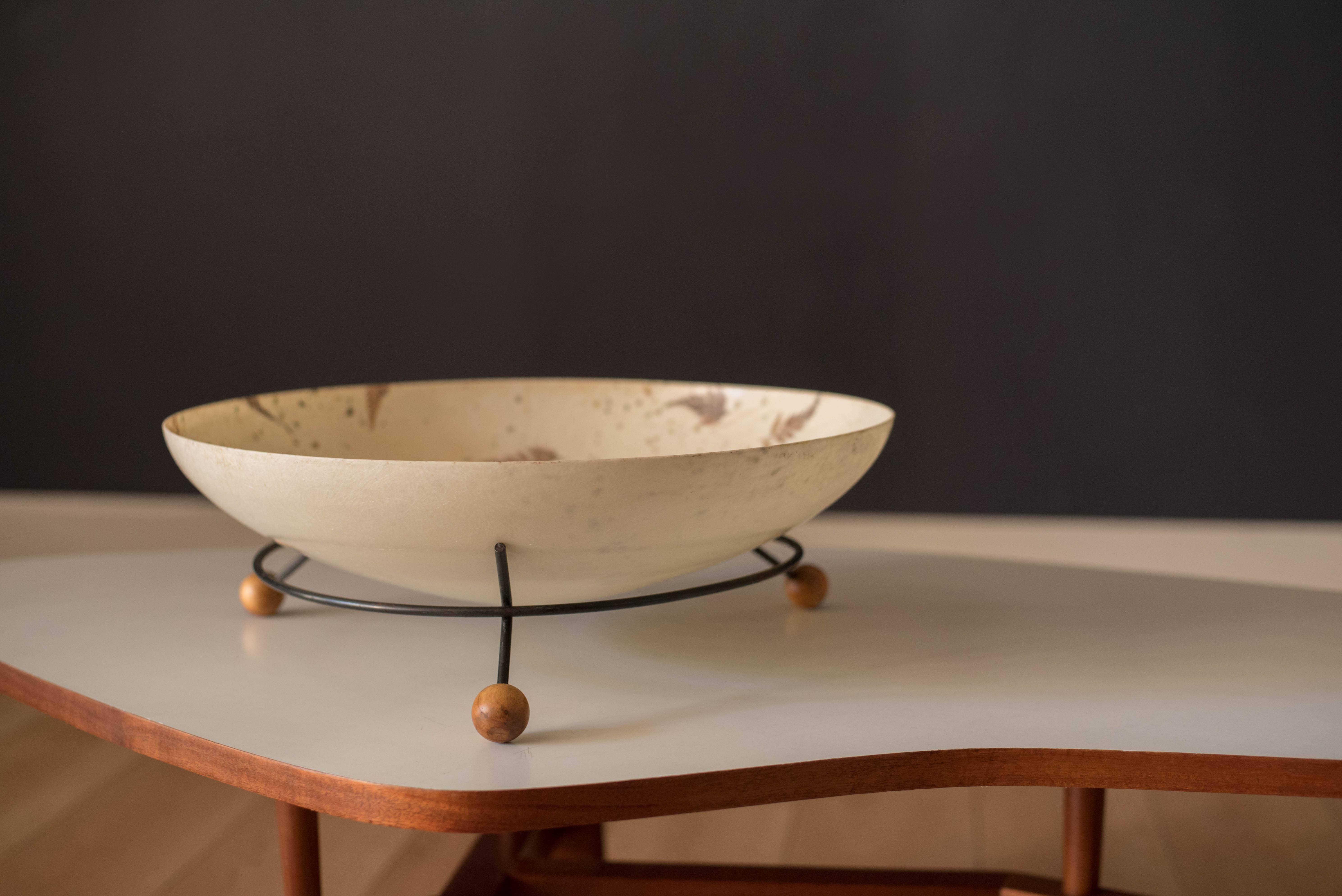 Vintage catchall decorative centerpiece tray, circa 1960s. This versatile display piece is perfect for stashing your belongings and home accessories. Includes a wide fiberglass bowl with a unique interior leaf inlay. Features a supporting iron ring