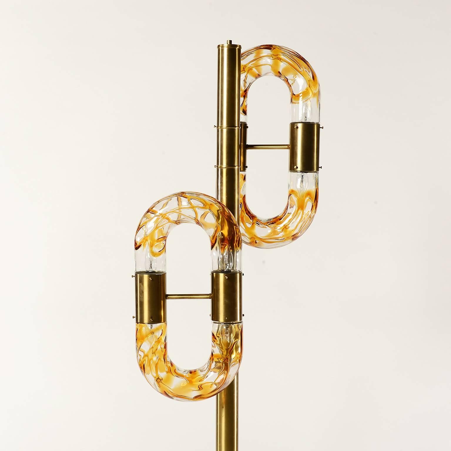 This Space Age six-light floor lamp was designed by Aldo Nason in the 1970s. It is made in Murano clear and amber colored glass and comes with a brass base.
A beautiful and elegant piece which fits perfect to modern, vintage or midcentury interior.