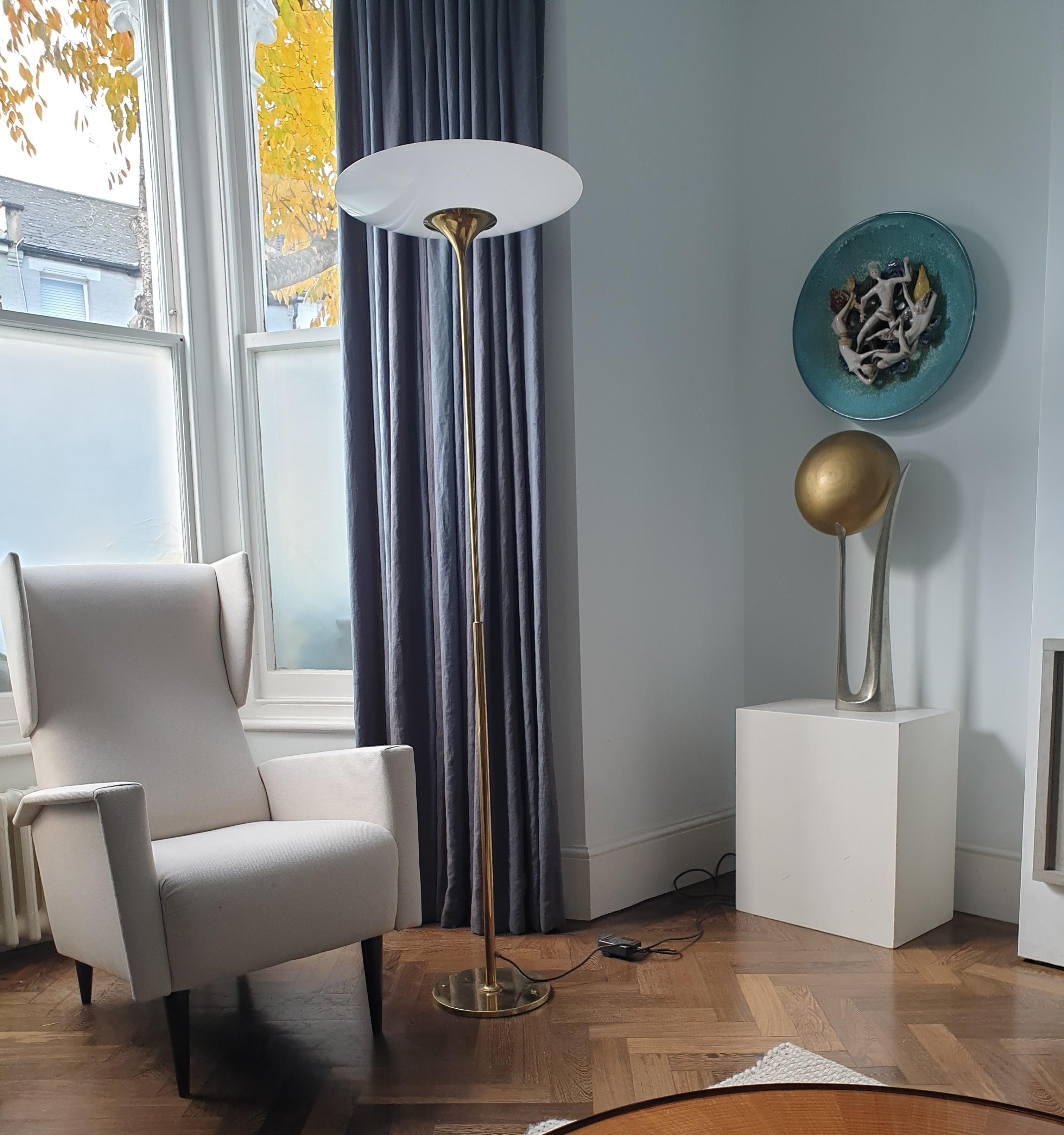 Elegant Floor lamp with brass base and stem and upcurved opaque glass shade by Atelier Jean Perzel, France. This tall floor lamp is perfect for rooms with high ceilings and its simplicity of form means it will grace any style of Interior - something