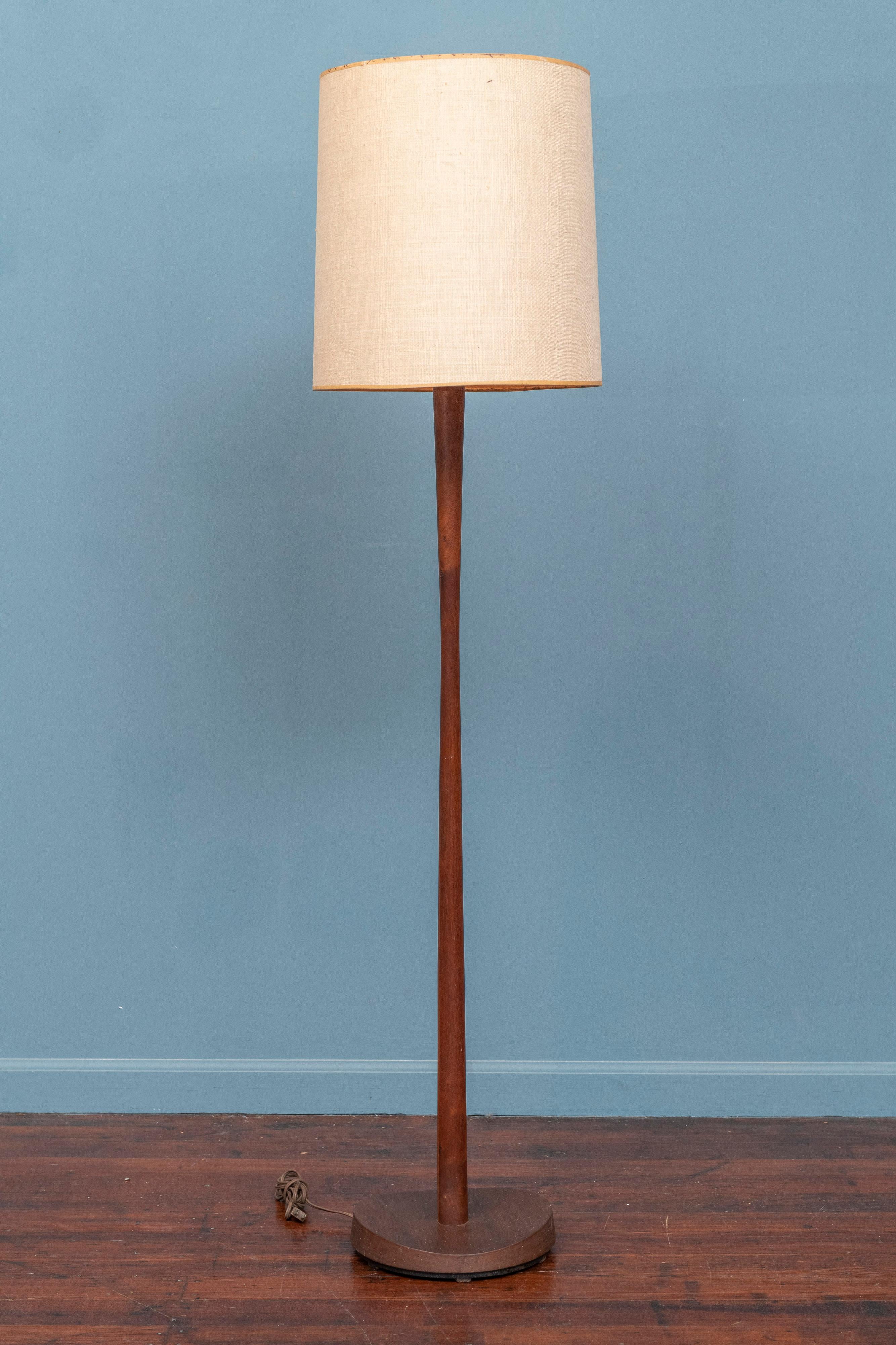 Mid-Century Modern sculpted teak floor lamp by Laurel Lamp Co. Sophisticated design made with high quality construction with a weighted base to prevent tipping, working and ready to install. 
Sold separately are two lamps, one a teak model featured