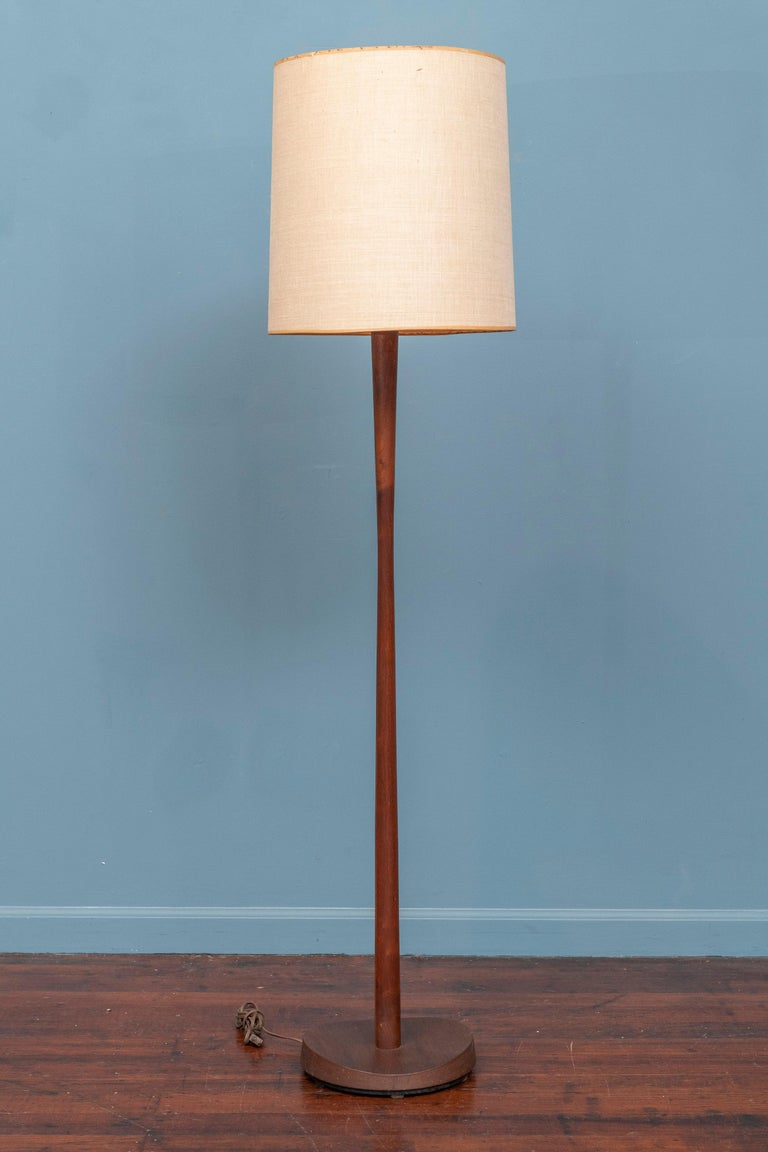 Mid-Century Modern sculpted teak floor lamp by Laurel Lamp Co. Sophisticated design made with high quality construction with a weighted base to prevent tipping, working and ready to install. 
Sold separately are two lamps, one a teak model featured