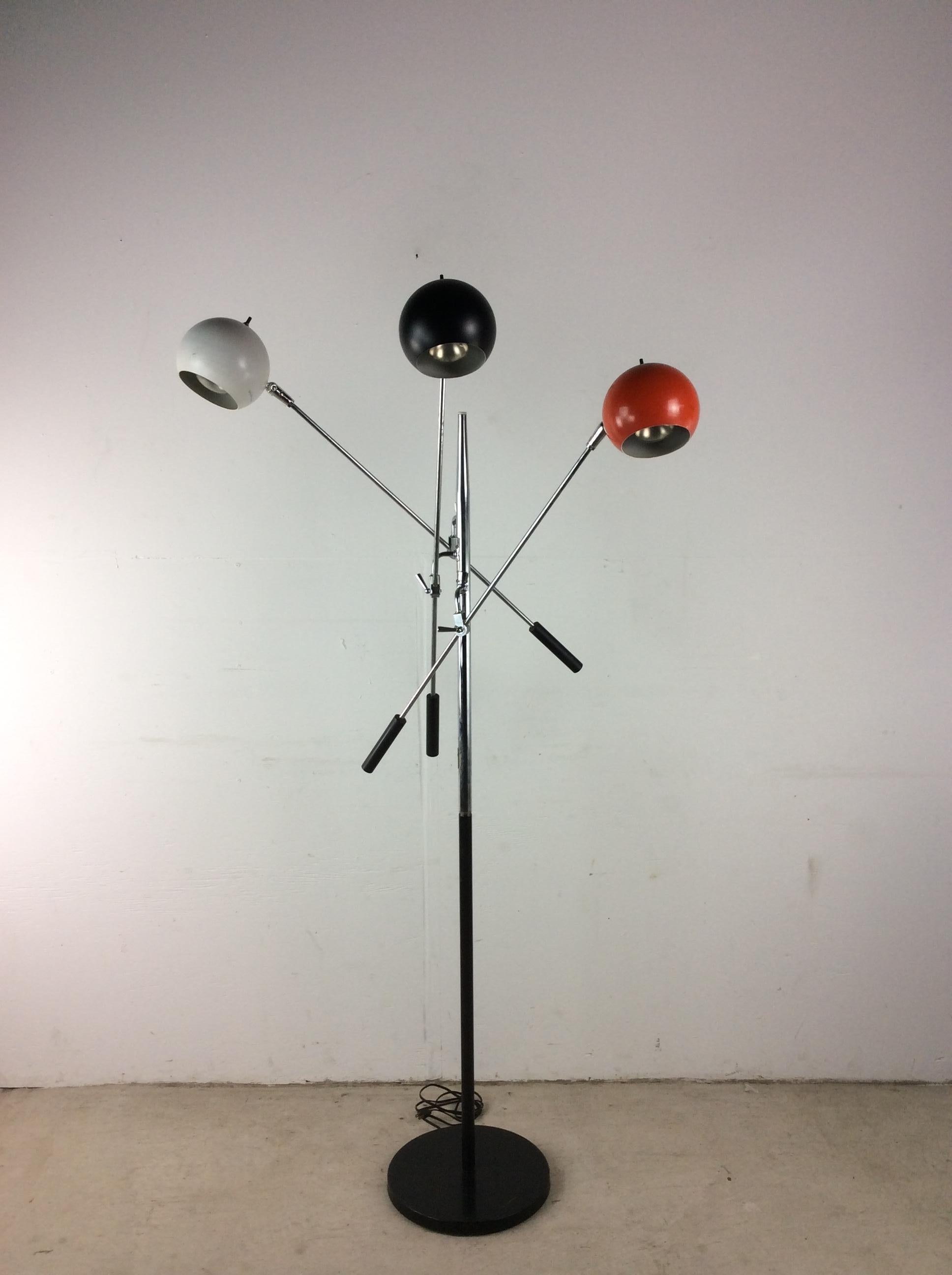 This vintage triennial floor lamp by Robert Sonneman features three painted globes (Red, white, black) each with its own chrome balancing arm and light switch. Globes pivot.   Lever arm: 36
