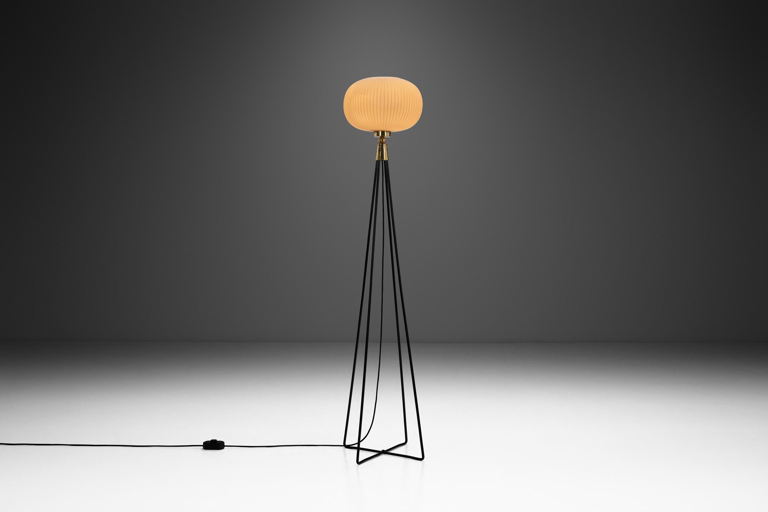At its most basic level, mid-century modern designs are known for juxtaposing sleek lines with organic shapes, using new materials and methods to reimagine traditional pieces. This floor lamp is a perfect example with a futuristic look that is an