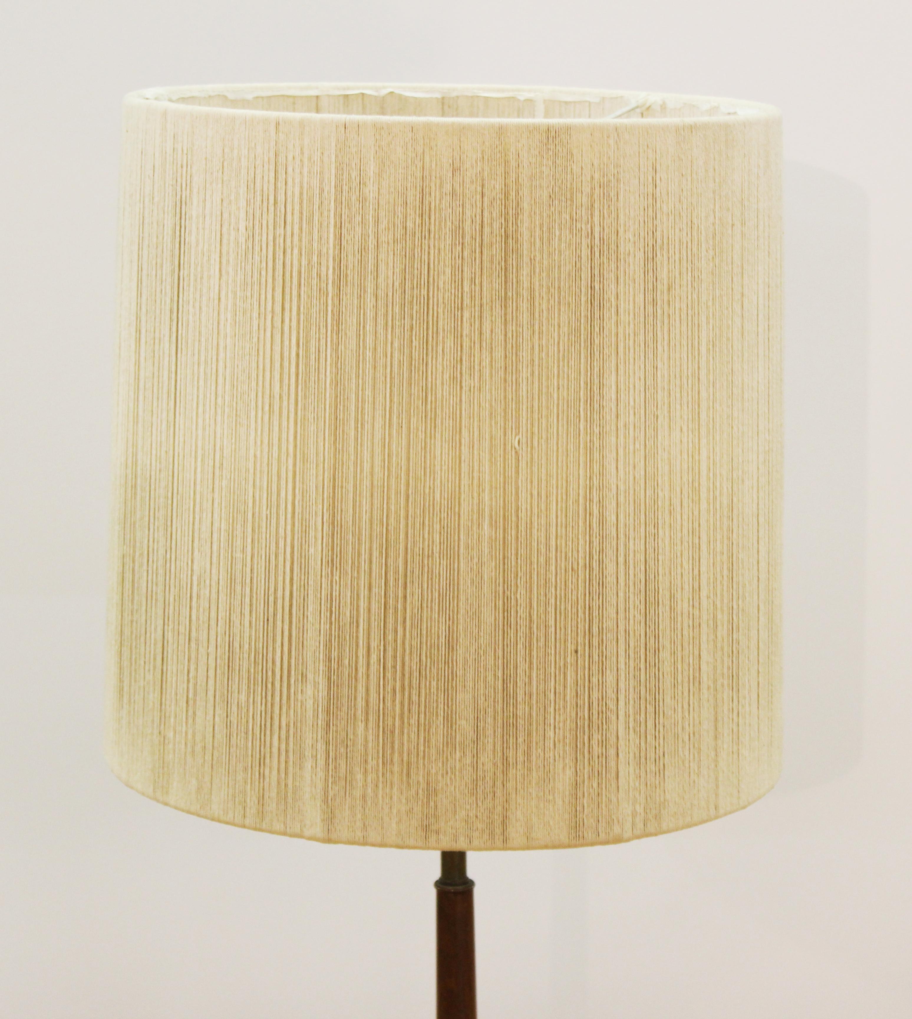 Mid-Century Modern floor lamp with wooden shaft and tripod metal legs. With original shade.
