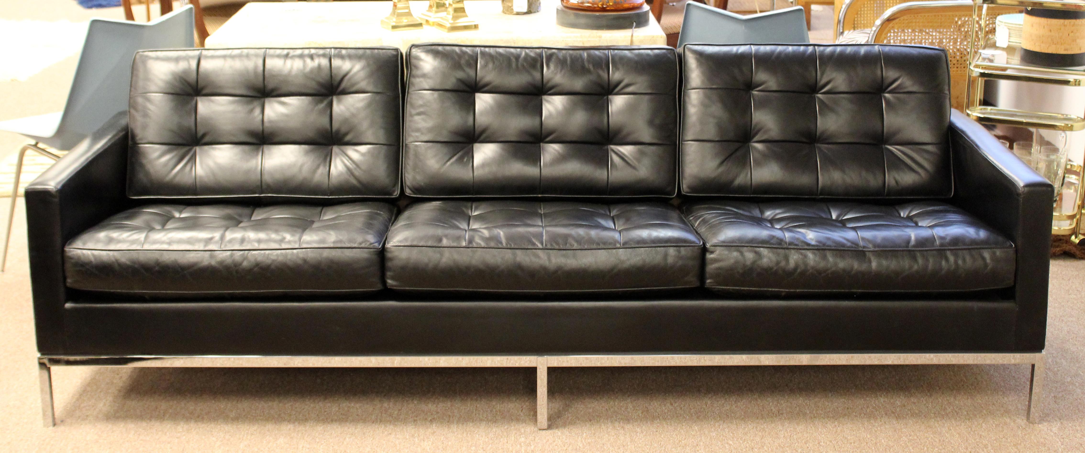 For your consideration is a vintage exceptional sofa, made of chrome and with tufted black leather upholstery, by Florence Knoll, with original tag, circa 1960s. In very good vintage condition. The dimensions are 89.5