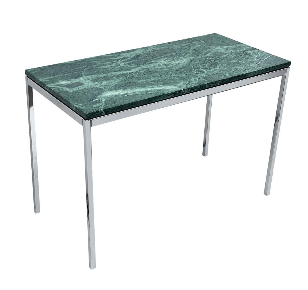 A simple classic designed by Florence Knoll for Knoll. This piece features a stainless steel base with verde green marble slab top.