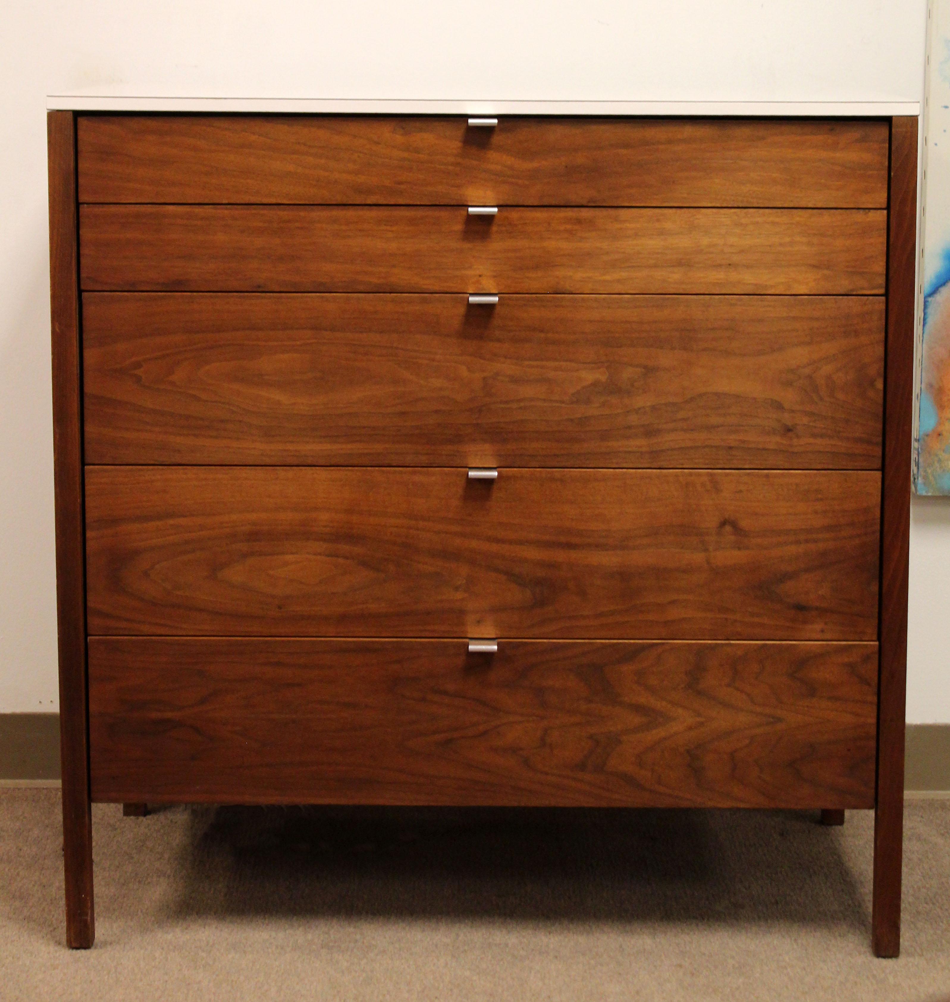 For your consideration is a marvelous, five-drawer dresser, made of wood, with chrome pulls and a laminate top, by Florence Knoll, circa the 1960s. In excellent condition. Has the original Knoll tags. The dimensions are 36