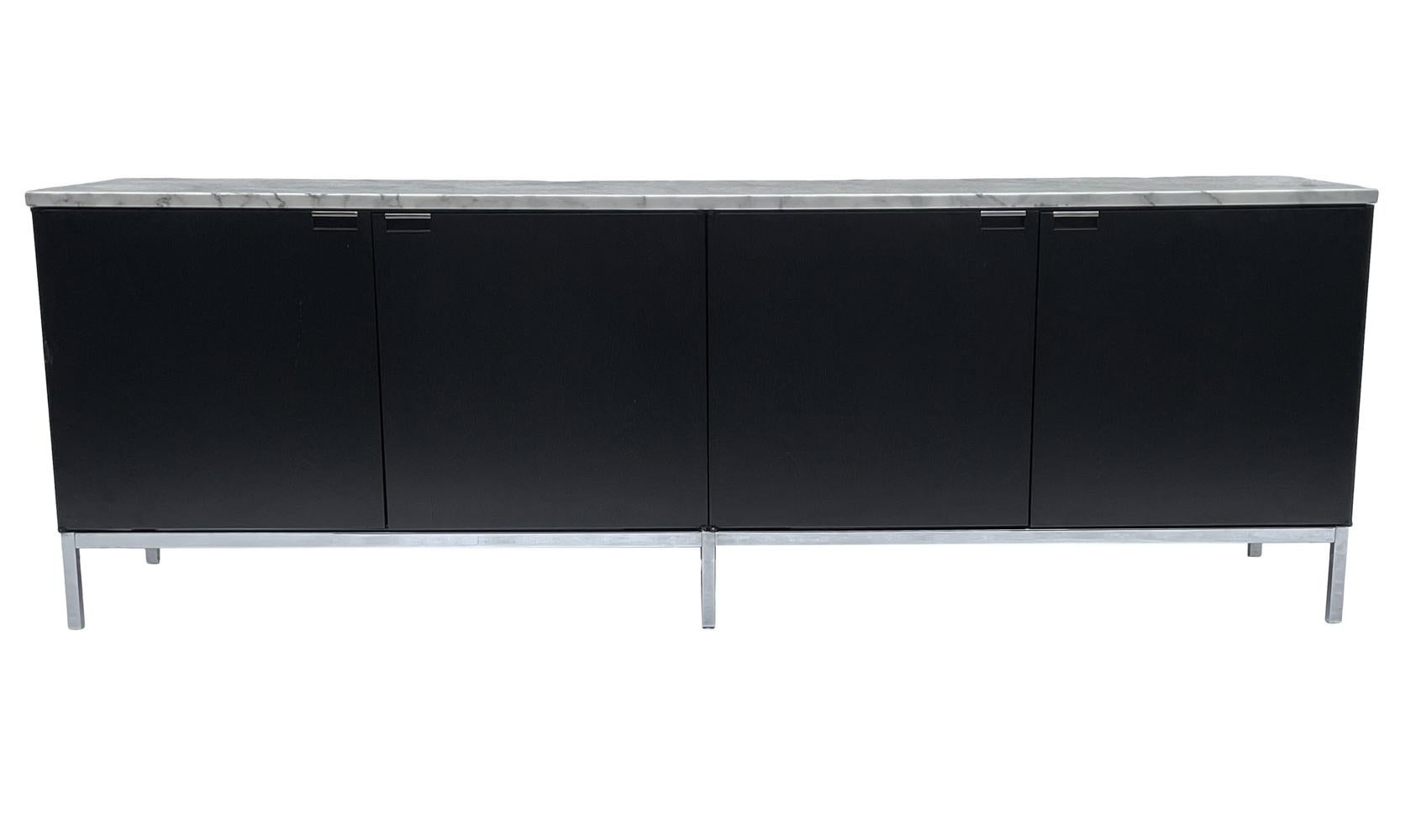 A classic simple modern credenza cabinet by Florence Knoll for Knoll. The cabinet features ebony stained oak with calacatta marble top. In beautiful condition.