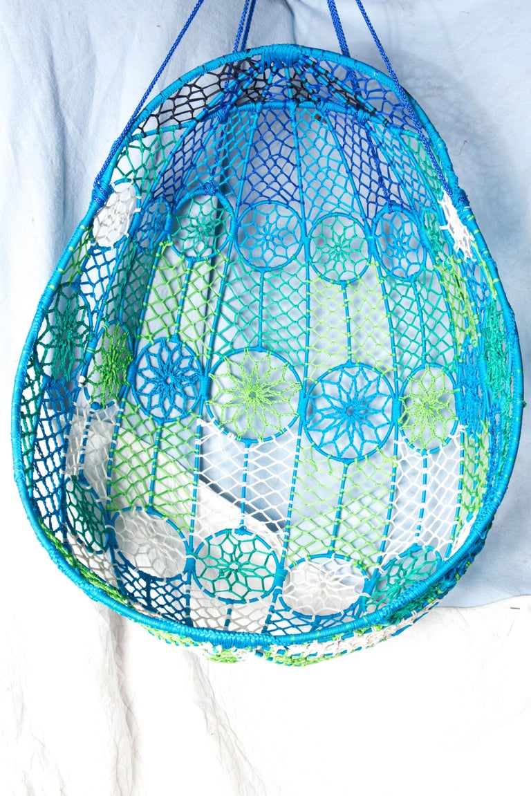 A one of a kind fun statement piece: Groovy Mod woven fiber cord hanging egg chair in blue, green and white. Comfortable and strong structure. In excellent vintage condition.
