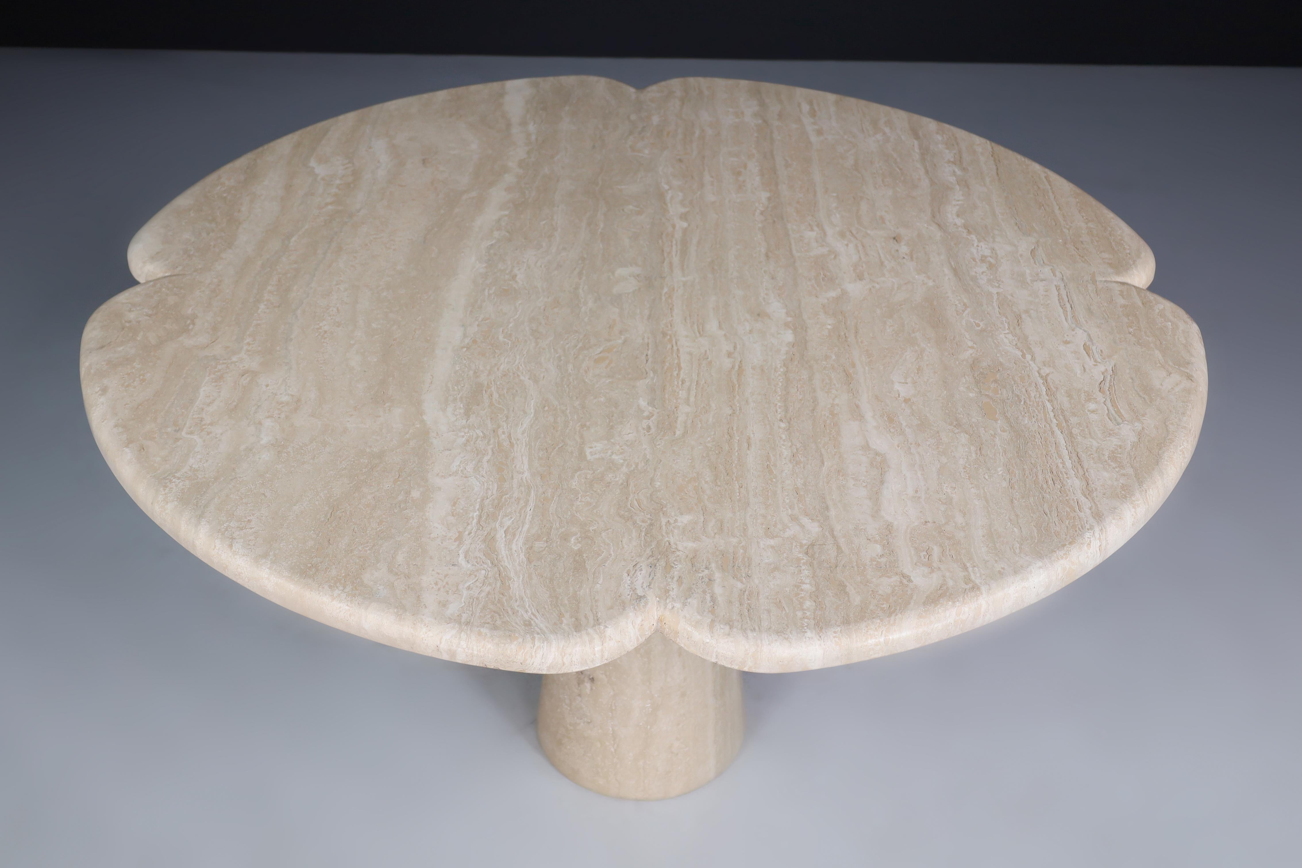 Flower-shaped top travertine dining table, Italy 1970s 

Beautiful flower-shaped top travertine dining table or centre table made in Italy in the 1970s. The thick heavy top sits on a solid travertine cone. Therefore, a lovely contrast is created