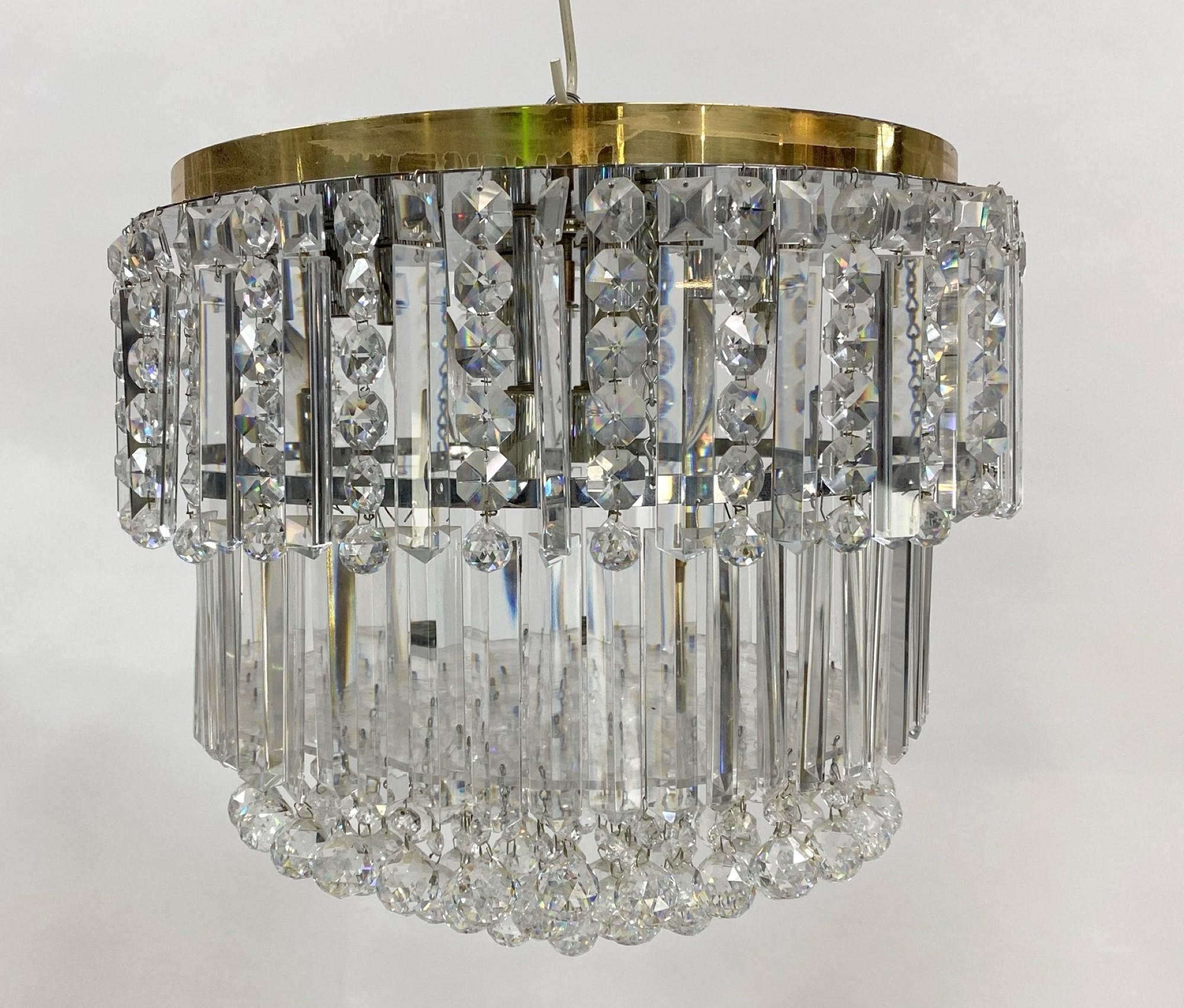 Mid-Century Modern flush mount chandelier dripping with crystals. Features a polished brass mounting base. Originaly installed as part of the decor of a Beverly Hills mansion. This can be seen at our 400 Gilligan St location in Scranton, PA.