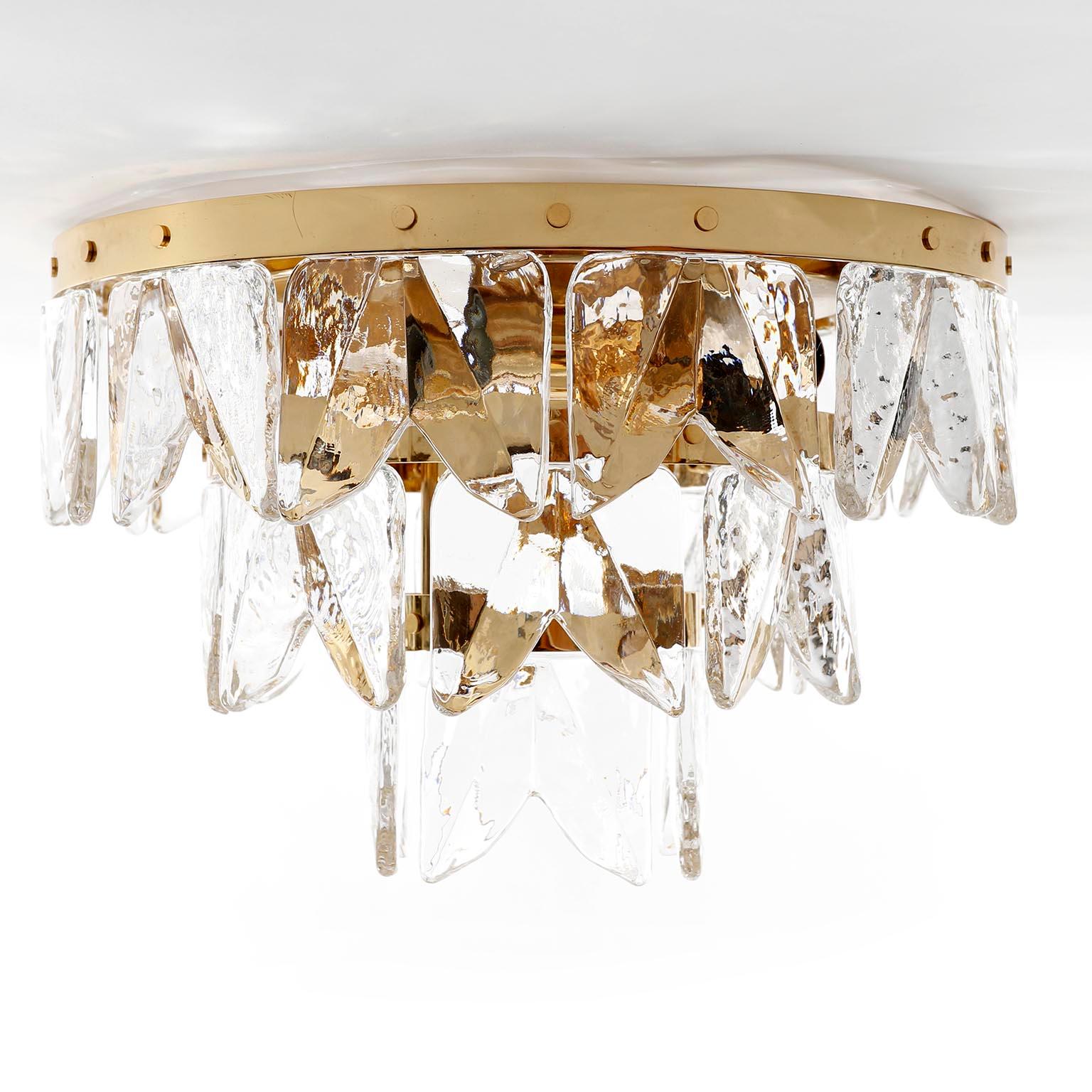 A very exclusive Hollywood regency ice glass flush mount light model 'Corina' by J.T. Kalmar, Vienna, Austria, manufactured in midcentury, circa 1970 (late 1960s or early 1970s).
A high quality item which is made of a 24-carat gilded polished brass