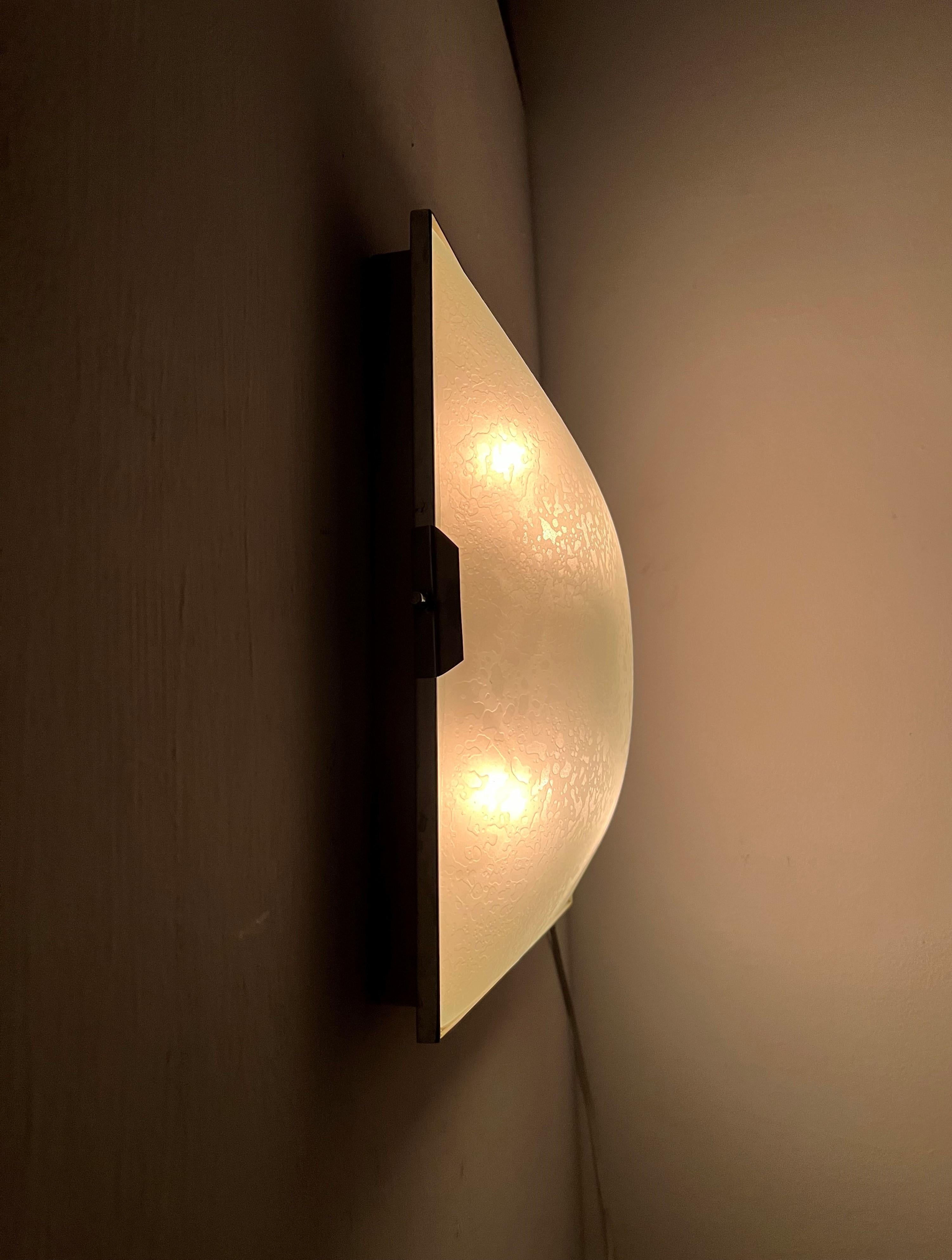 Wall or flush mount lamp in chromed brass, white lacquered metal body and pressed and frosted glass . The light is stamped in the back 