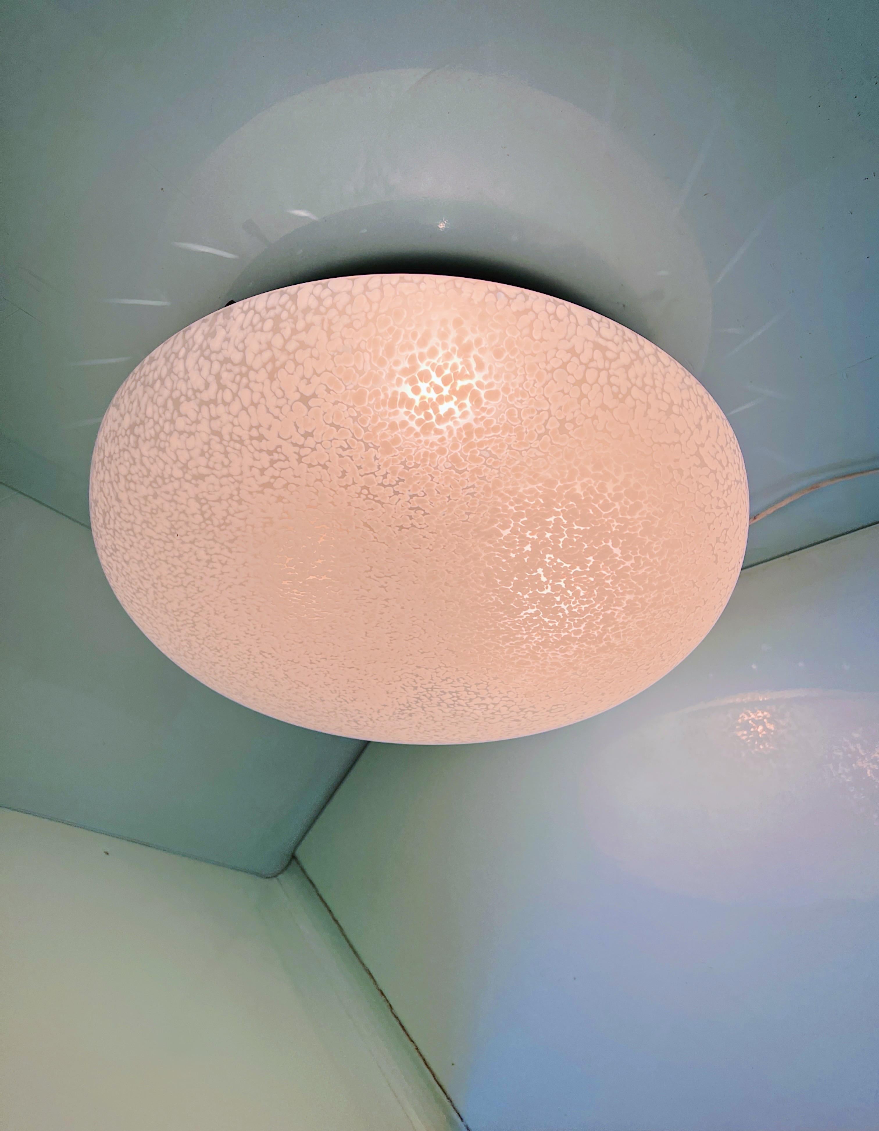 This large vintage Murano glass ceiling or wall light was designed by Carlo Nason in 1960s. The glass is adorned with dots that create a amazing interplay of light when lit. What's even more versatile is that you can mount it on both the ceiling and