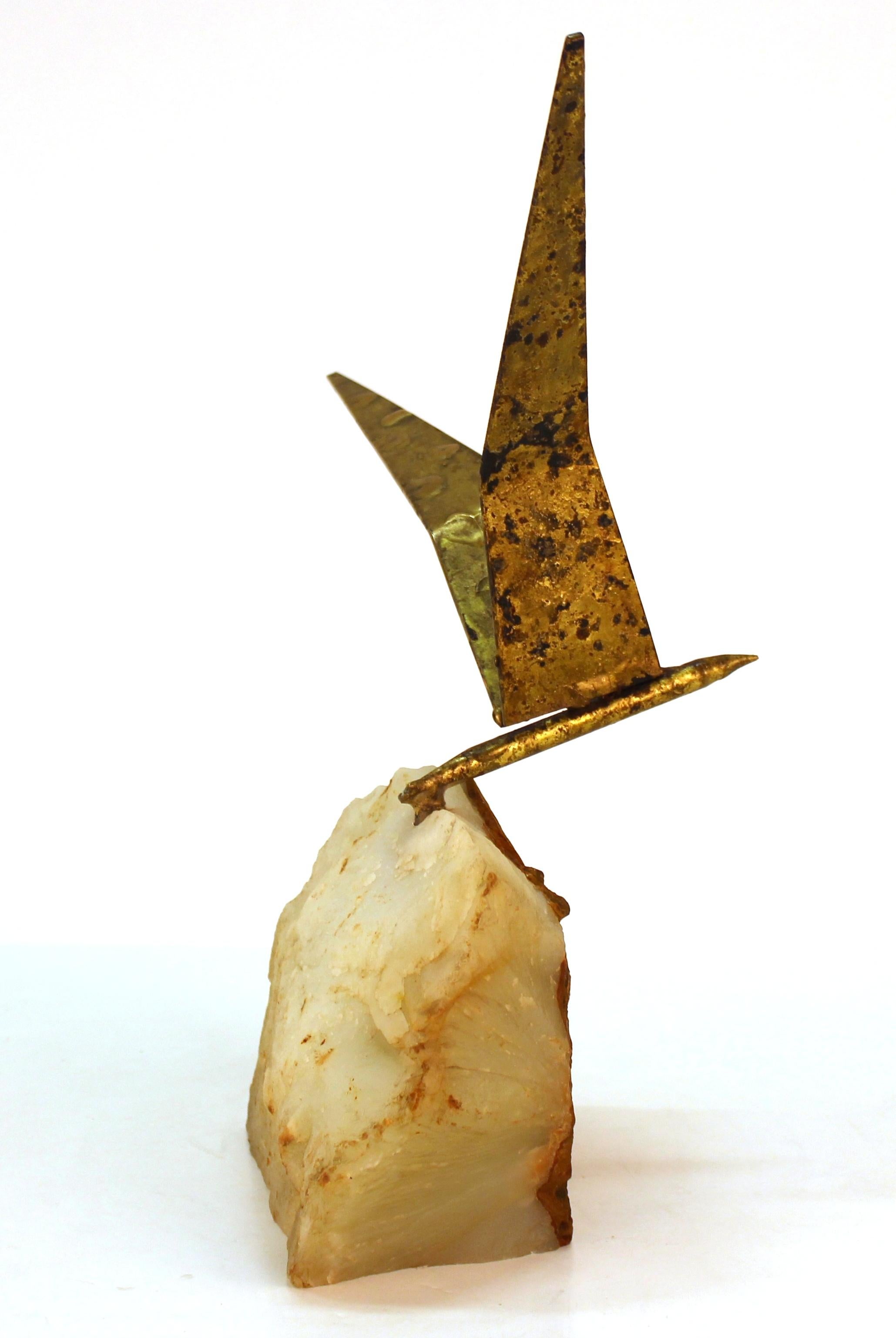 Mid-Century Modern sculpture of a gilt iron bird in flight fixed atop a base made of a quartz and magma mineral specimen. The position of the bird can be modified. The piece was created in the mid-20th century, presumably in the United States and is