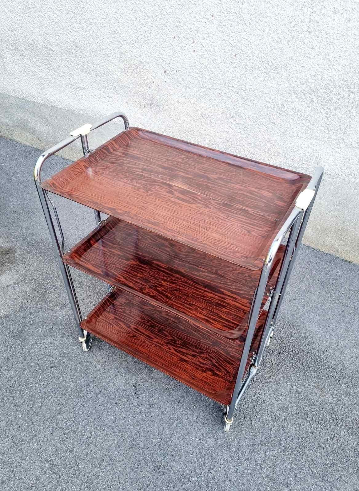 Serving Trolley was made in Germany in the late 60's, it was primarily used as a tea trolley.

It's made of a silver chrome frame and three brown plastic shelves, with a smooth finish. It's very versatile and practical.

It can be used as a stand