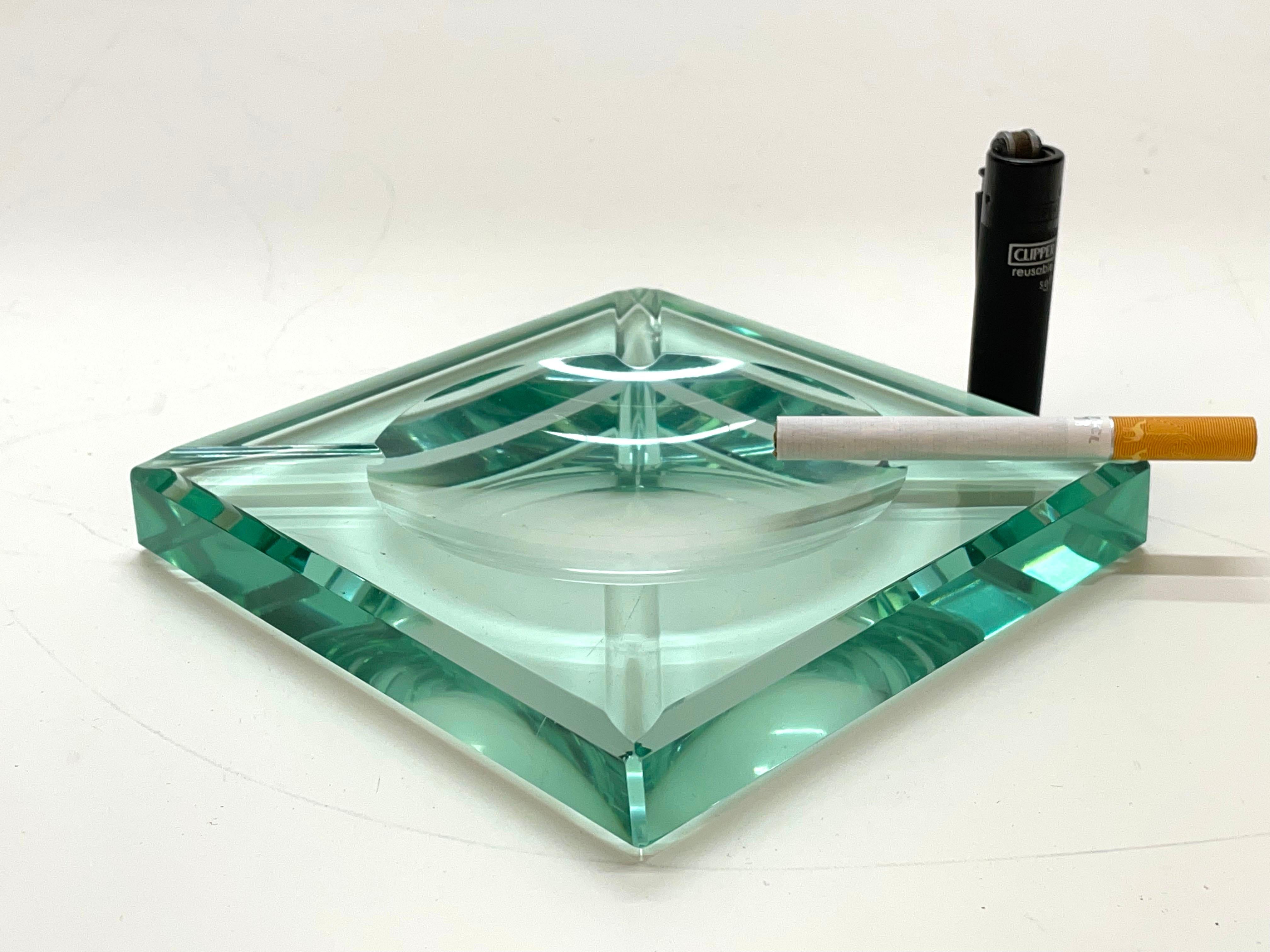 Amazing Mid-Century Modern green glass squared ashtray. This wonderful piece was produced by Fontana Arte in Italy during the 1960s.

The item is in squared green crystal glass with geometrical carving, the classical design by Fontana Arte from