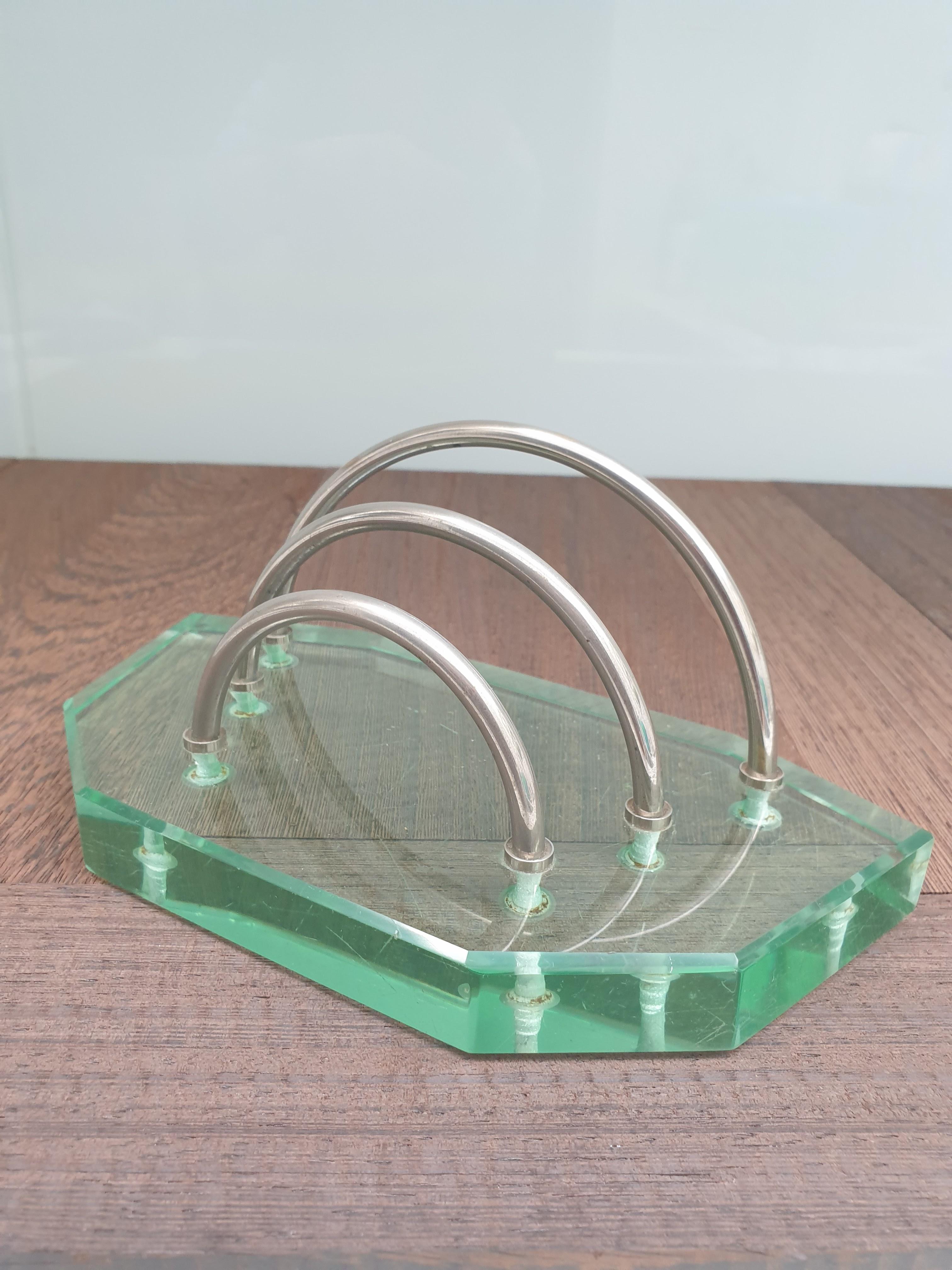 Thick pale glass letter rack useful for a desk. This is an early Model due to the pale green colour of the glass. The metal partitions that  hold the letters are in nickel. The glass itself is very thick 2cm deep as befits the quality of the