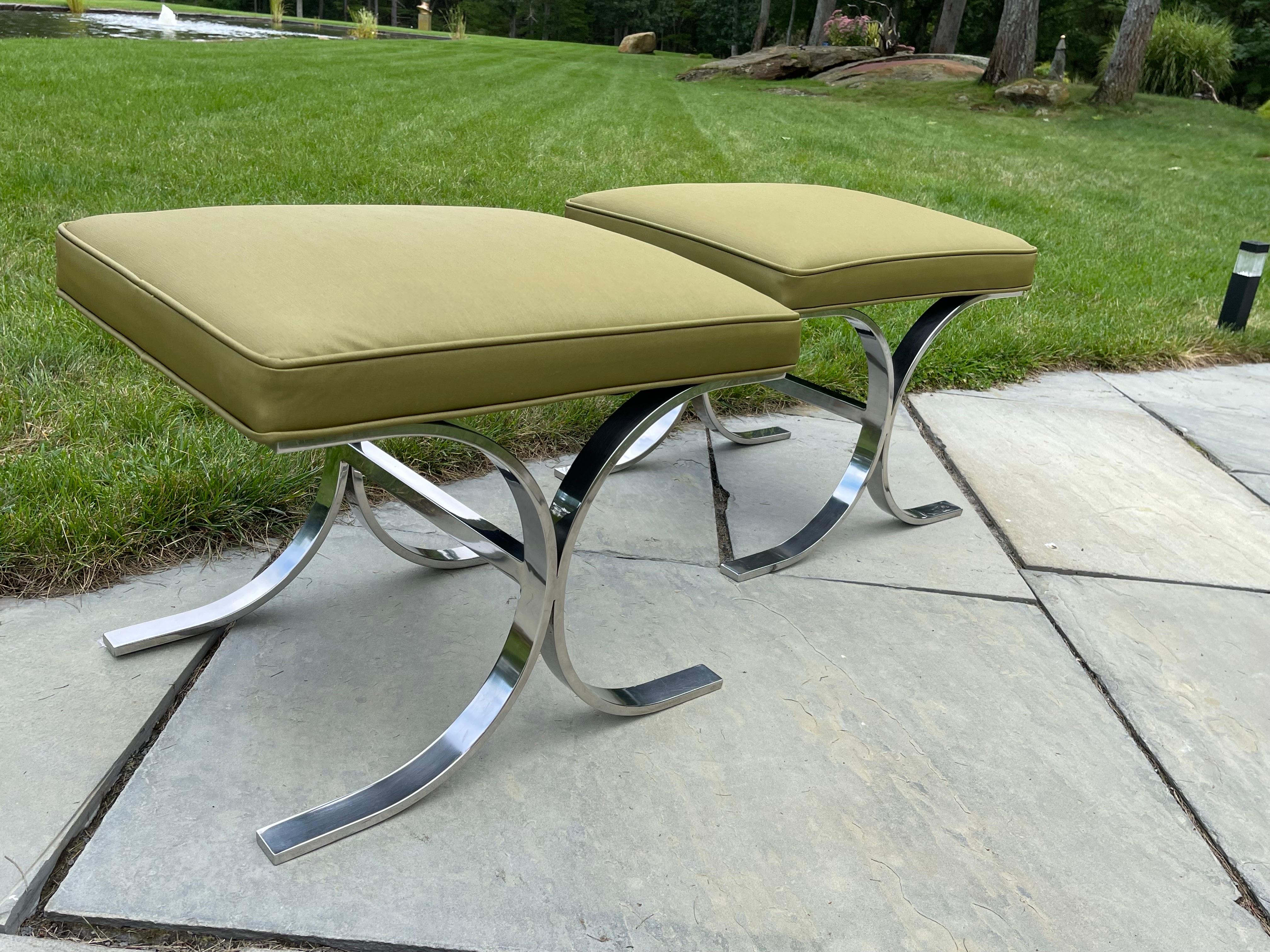 Inspired by Milo Baughman this pair of high quality Foot Stools is newly upholstered in a quality olive green fabric. 
The Cantilever heavy chrome x-shape legs are inspired by Milo Baughman’s work, a Pioneer of American Mid-Century Modern furniture.
