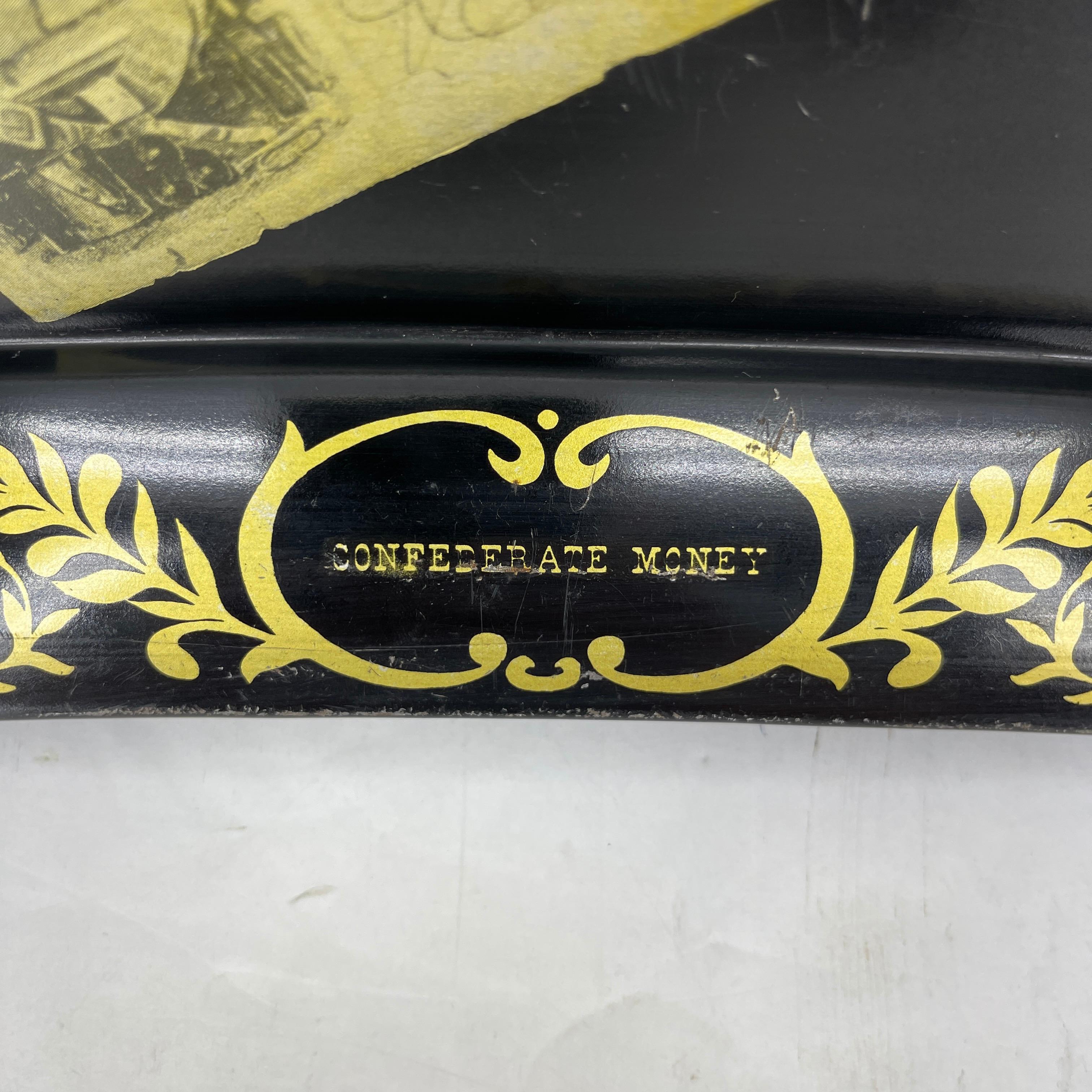Painted metal tray with scalloped edges bearing the confederate money notes of early America. This mid-size serving tray is perfect for serving your guests. The painted gold trim and confederate money is bold and fun. In very good condition, a