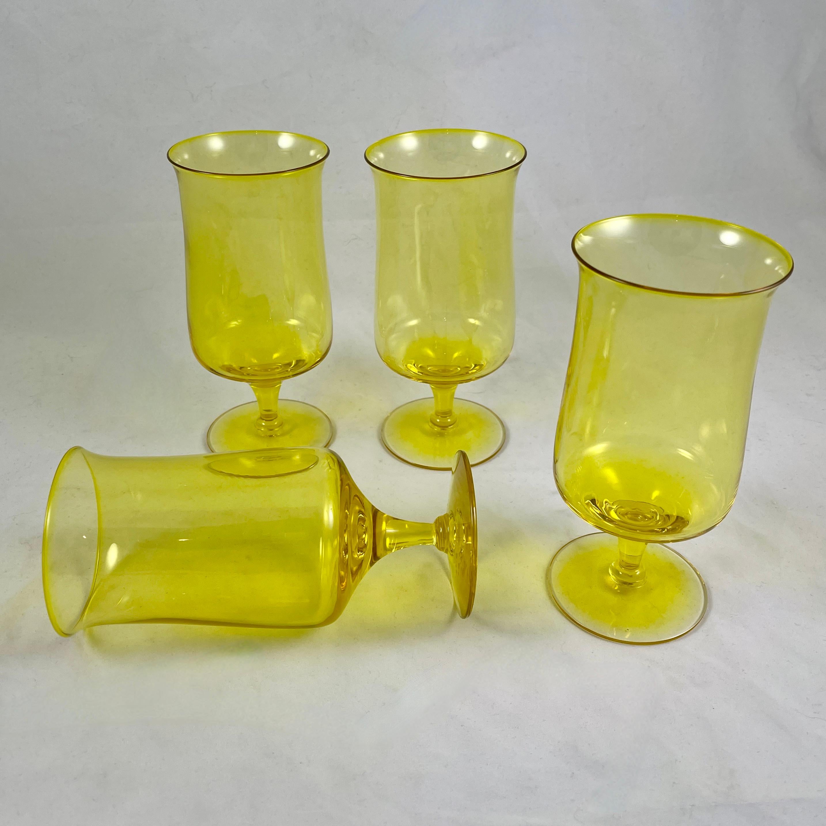 If you are looking to add some sunshine to your table, these tall glasses are for you.

From Fostoria Glass, a set of four Mid Century Modern era ice tea glasses in the Biscayne gold pattern, produced from 1971-1973.

The glasses are blown in a