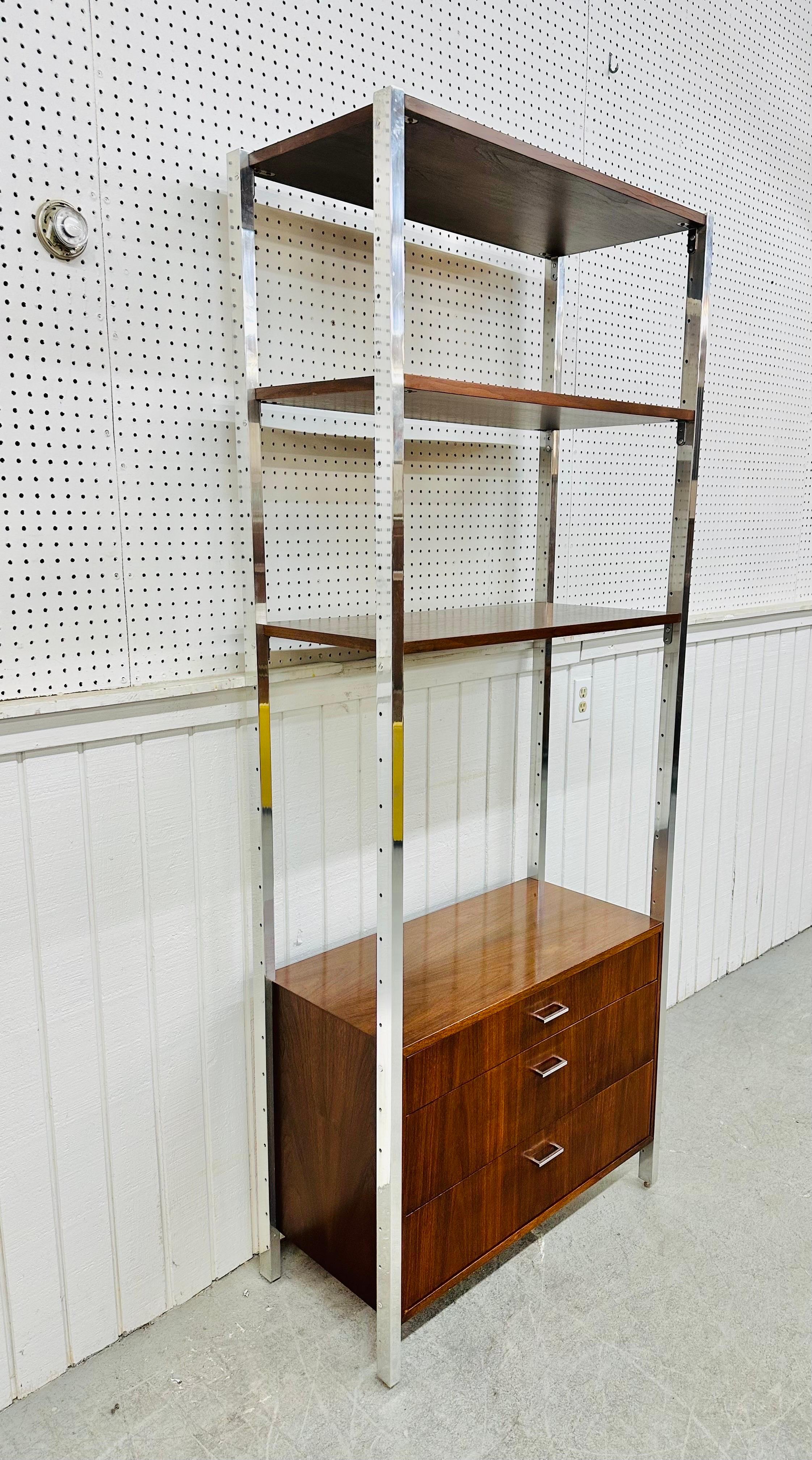 This listing is for a Mid-Century Modern Founders Chrome & Walnut Etagere. Featuring a straight line design, floating walnut chest of three drawers, walnut shelves, chrome pillars, and original chrome hardware. This is an exceptional combination of