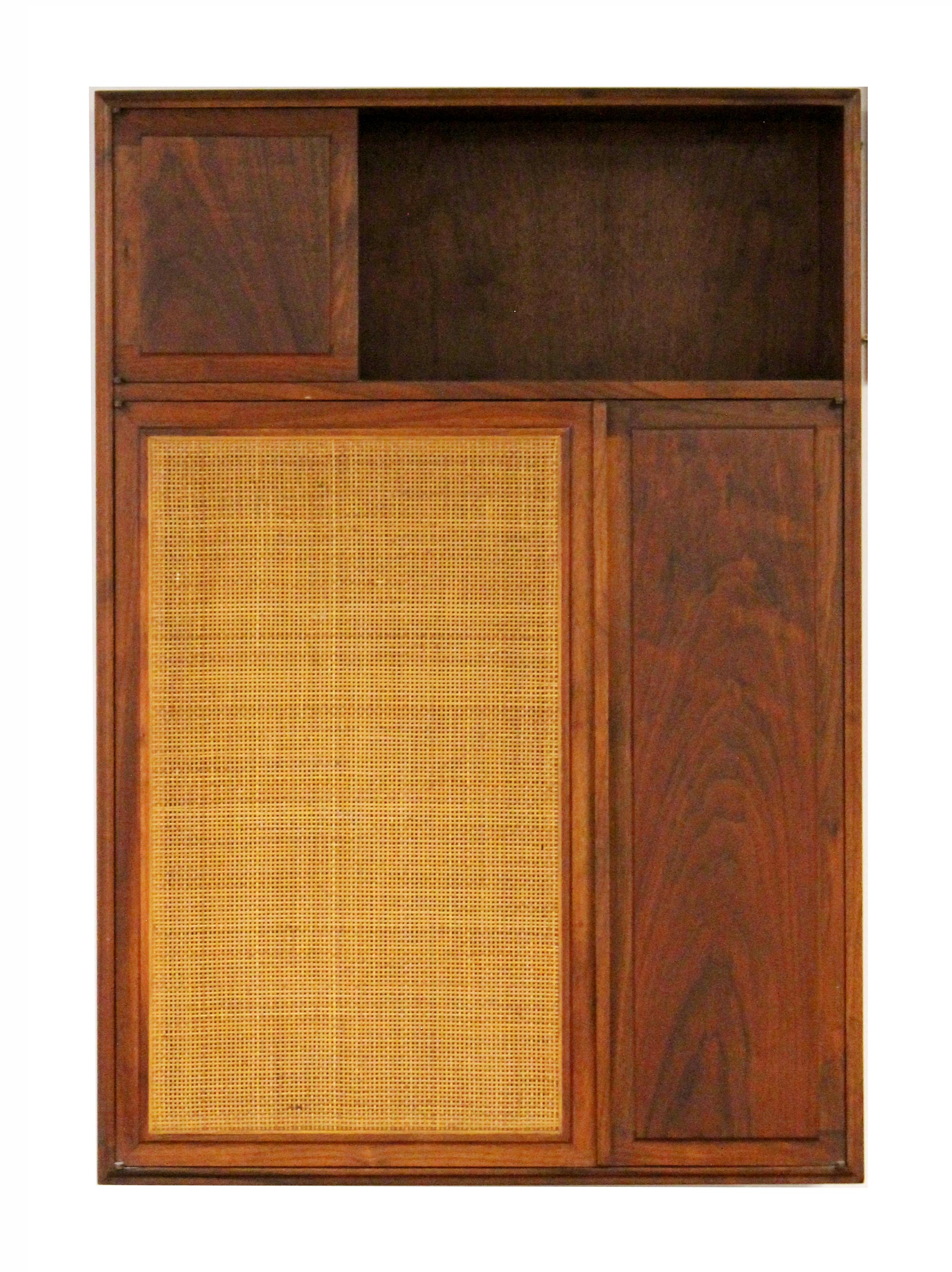 For your consideration is an outstanding Founders set, a hanging cabinet wall unit, made of walnut wood and cane, and a walnut credenza, circa the 1960s. In excellent vintage condition. The dimensions of the hanging cabinet are 33.5