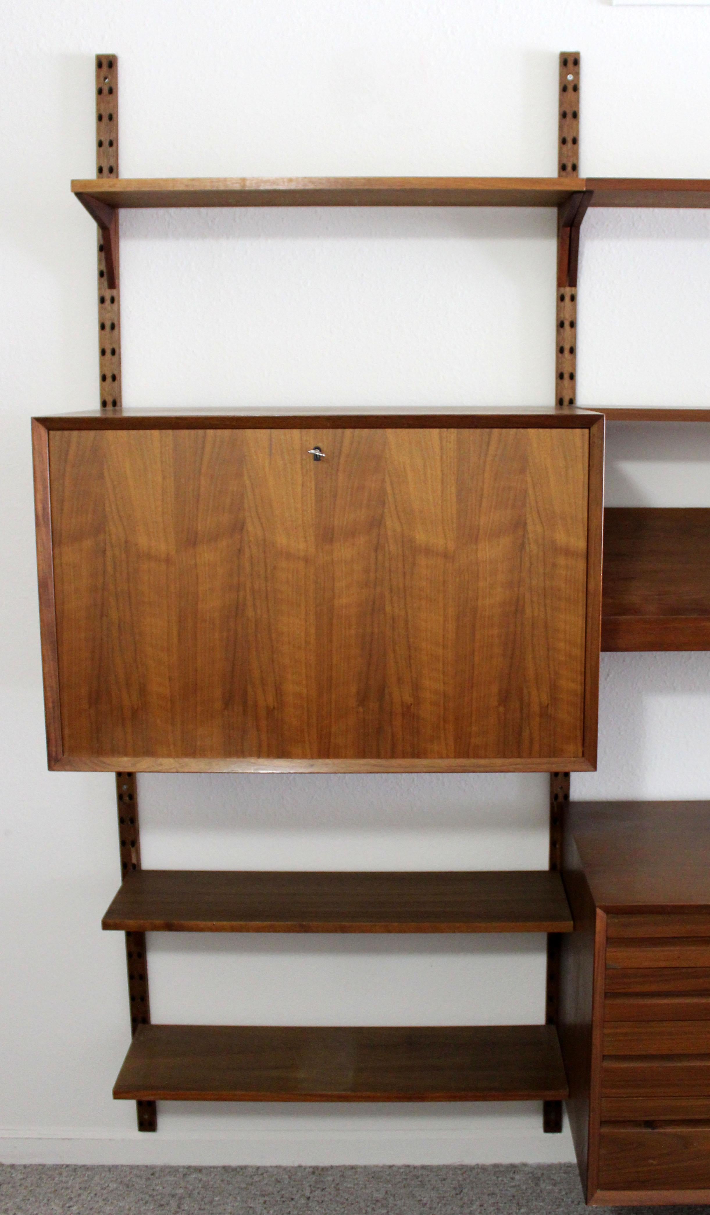 For your consideration is a magnificent, massive wall unit, made of walnut, with three cupboards and eight shelves by Founders, circa 1960s. In excellent condition. The dimensions are 127.5