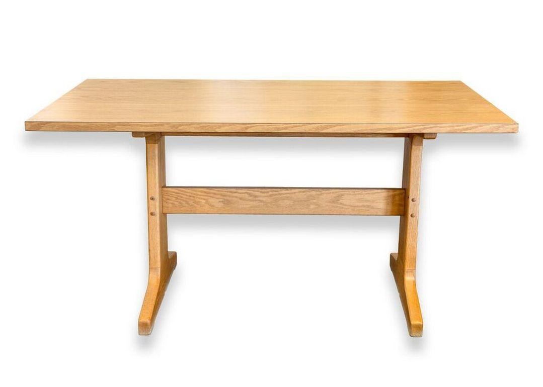 A mid century modern wood desk table with laminate wood table top. This handsome piece features a full solid wood construction, a minimalistic design, and a laminate wood finish on the table top. This piece is in very good condition overall, but