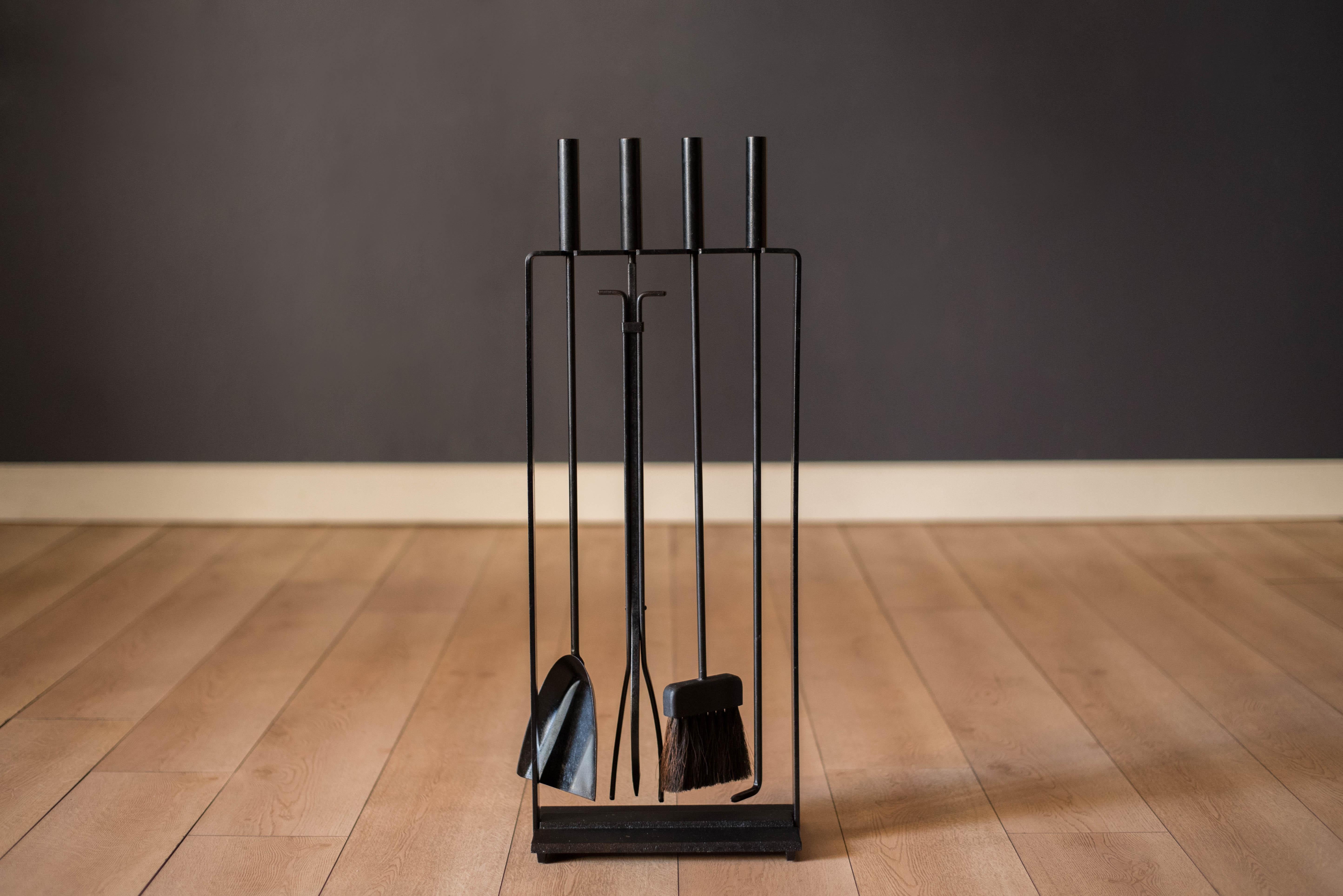 Vintage four piece fireplace tools with floor stand by Pilgrim Manufacturing circa 1960's. This set is made of heavy cast iron with black enamel handles. Includes poker, shovel, tongs and brush.