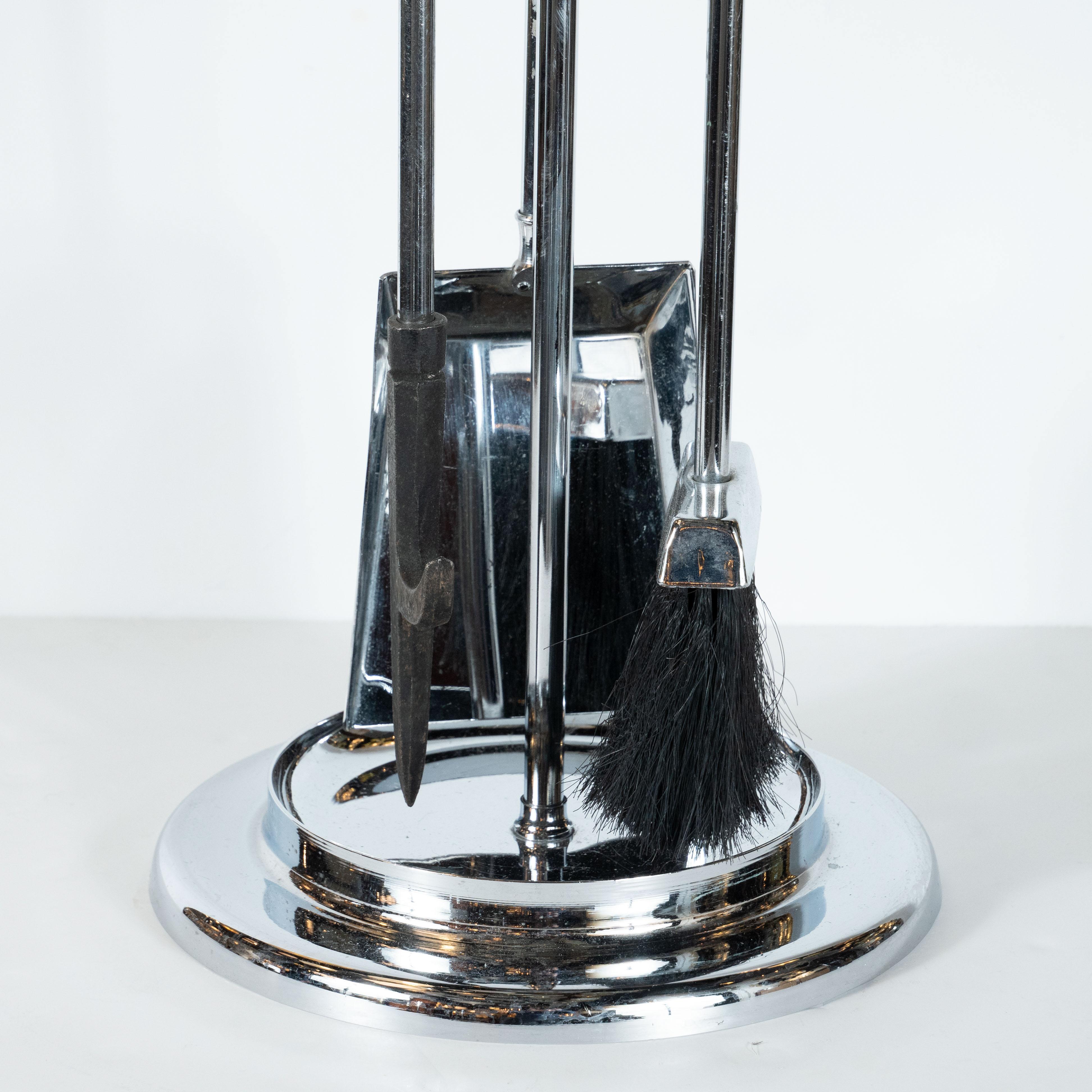 This refined Mid-Century Modern four piece fireplace tool set was realized in the United States, circa 1970. It includes a shovel, brush, and poker all in lustrous polished chrome with clear Lucite handles. The tools are presented on an elegant