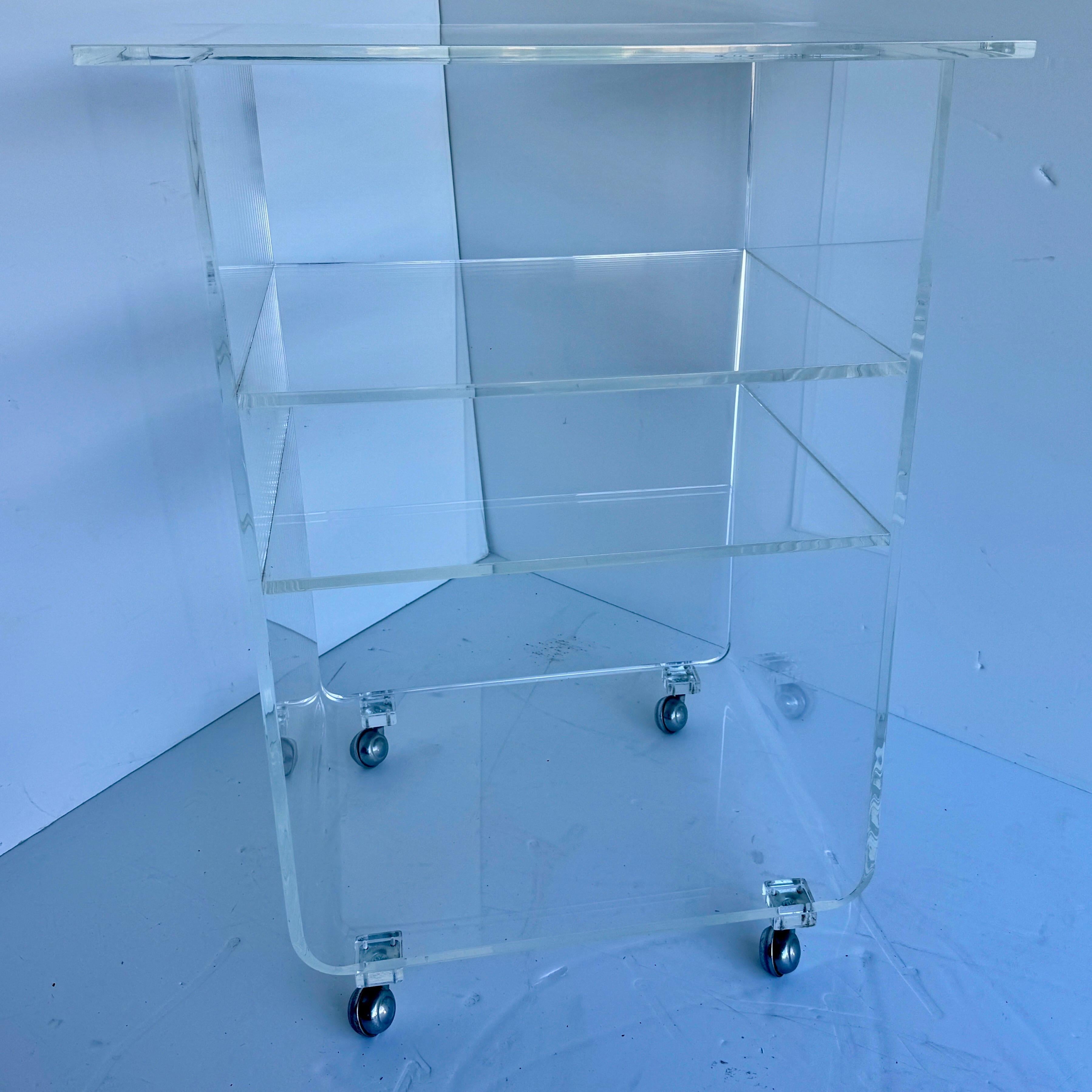 MCM Tiered Lucite Bar Serving Cart, 1970's

Mid-Century Modern multi-purpose lucite serving bar cart or trolley. This cart features 4 classic metal wheels. This minimalist cart certainly gives off a  wonderful Mid-Century vibe.