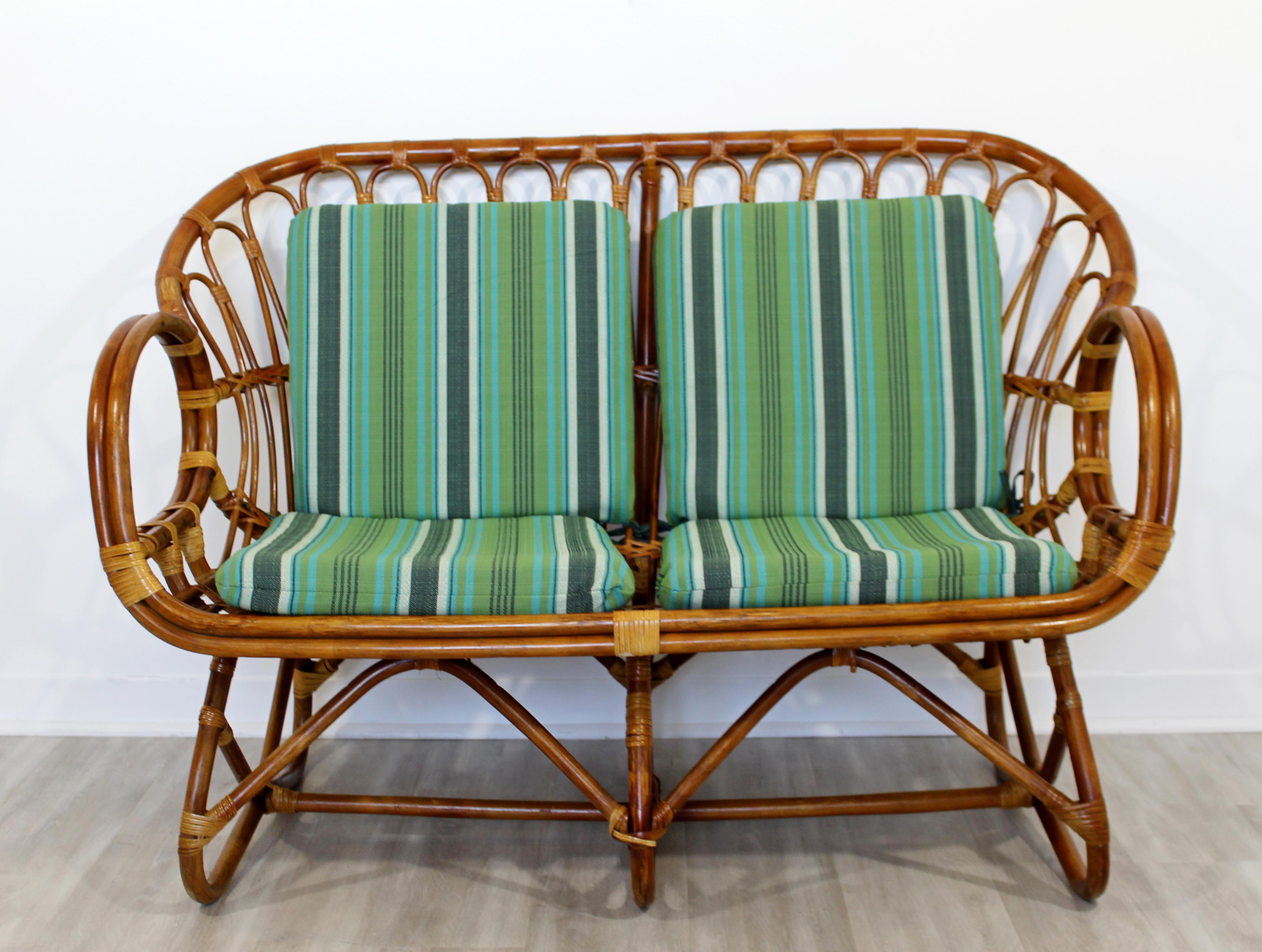 For your consideration is a sculptural settee loveseat, made of bamboo rattan, by Franco Albini, circa 1960s. In very good vintage condition. The cushions, are new. The dimensions are 49