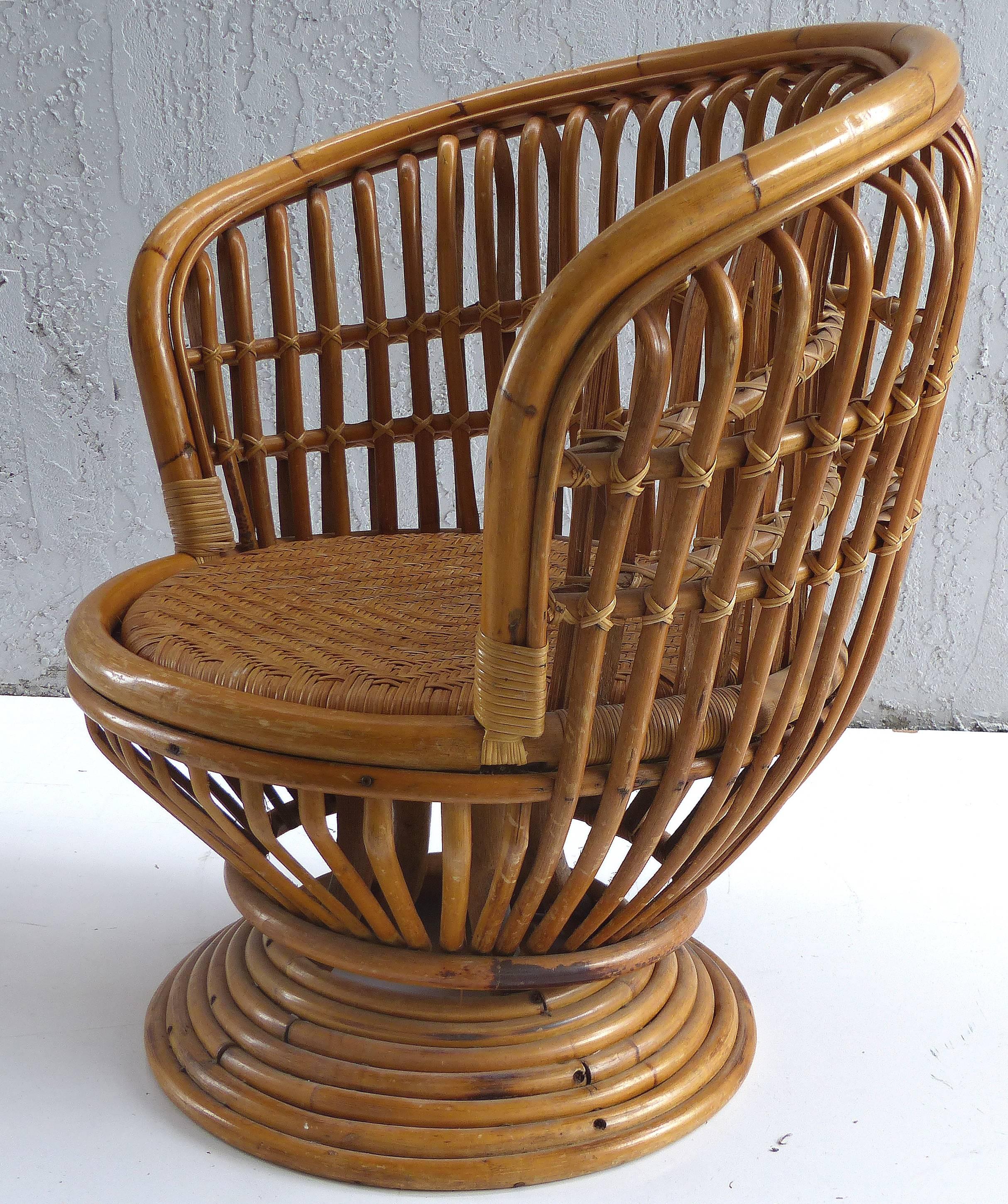Offered for sale is a Mid-Century Modern bent rattan swivel chair by Italian designer Franco Albini. The seat is woven split rattan and measures: 15