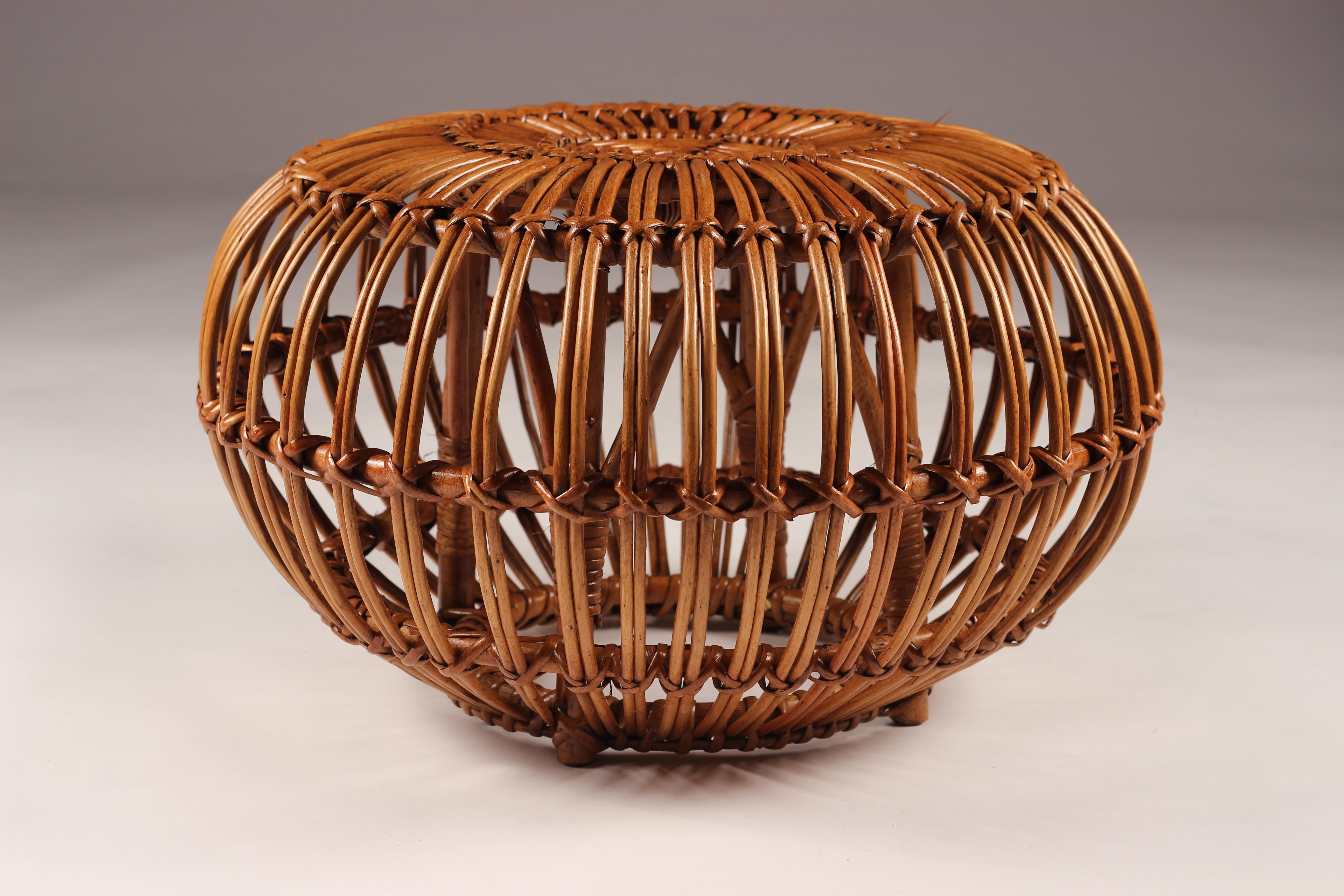 A vintage midcentury round wicker ottoman, stool or side table in good condition. A completely versatile piece that adds warmth and a handmade craftsmanship. In the era of flower power and Bohemian thinking, this piece would make a complimentary
