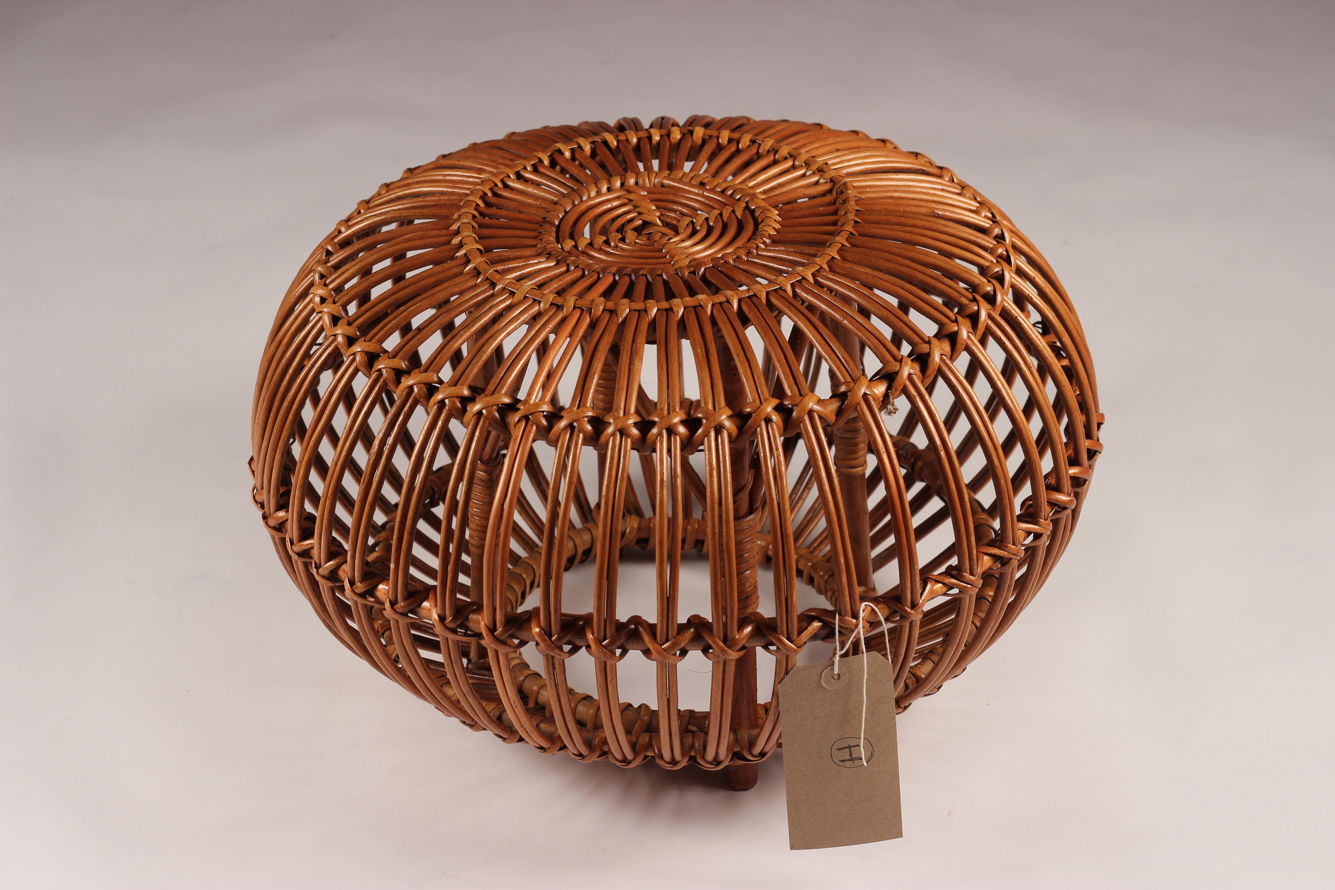 A vintage midcentury round wicker ottoman, stool or side table. A completely versatile piece that adds warmth and a handmade craftsmanship. This is one of 14 pieces we currently have in stock. Stock ref: (H).