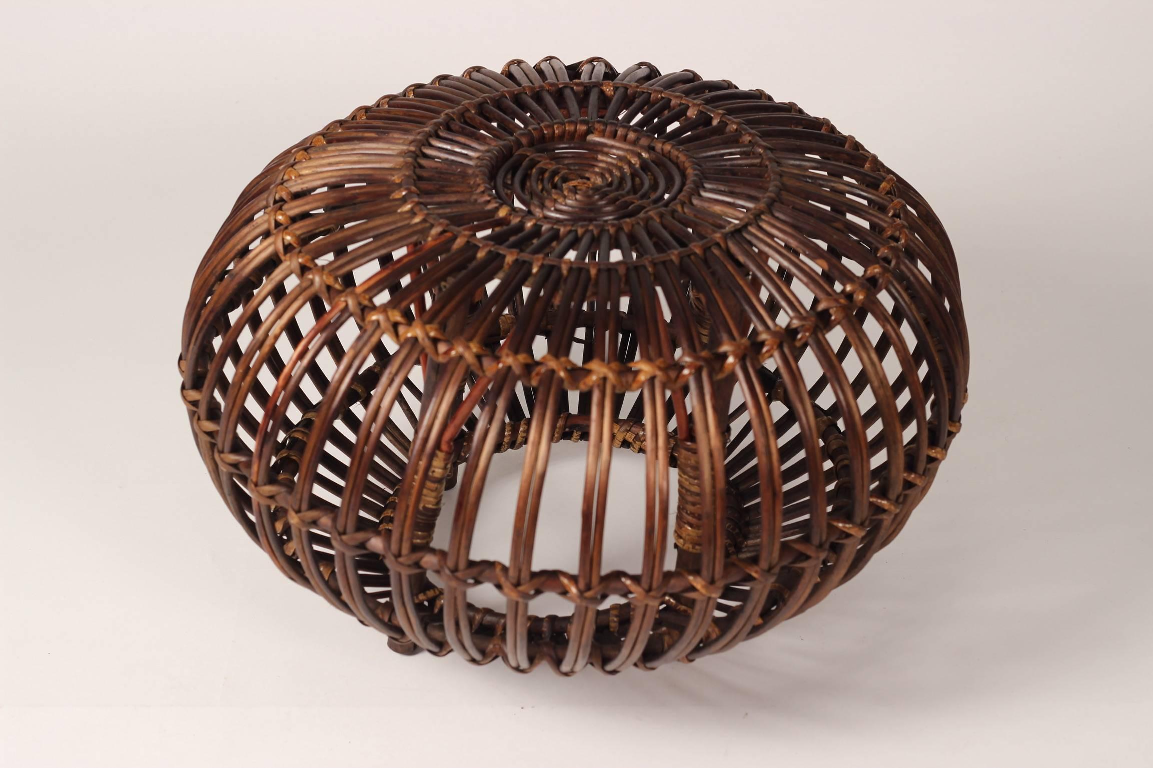 A vintage midcentury round wicker ottoman, stool or side table by designer Franco Albini. A completely versatile piece that adds warmth and a handmade craftsmanship. This is one of five pieces we have.
