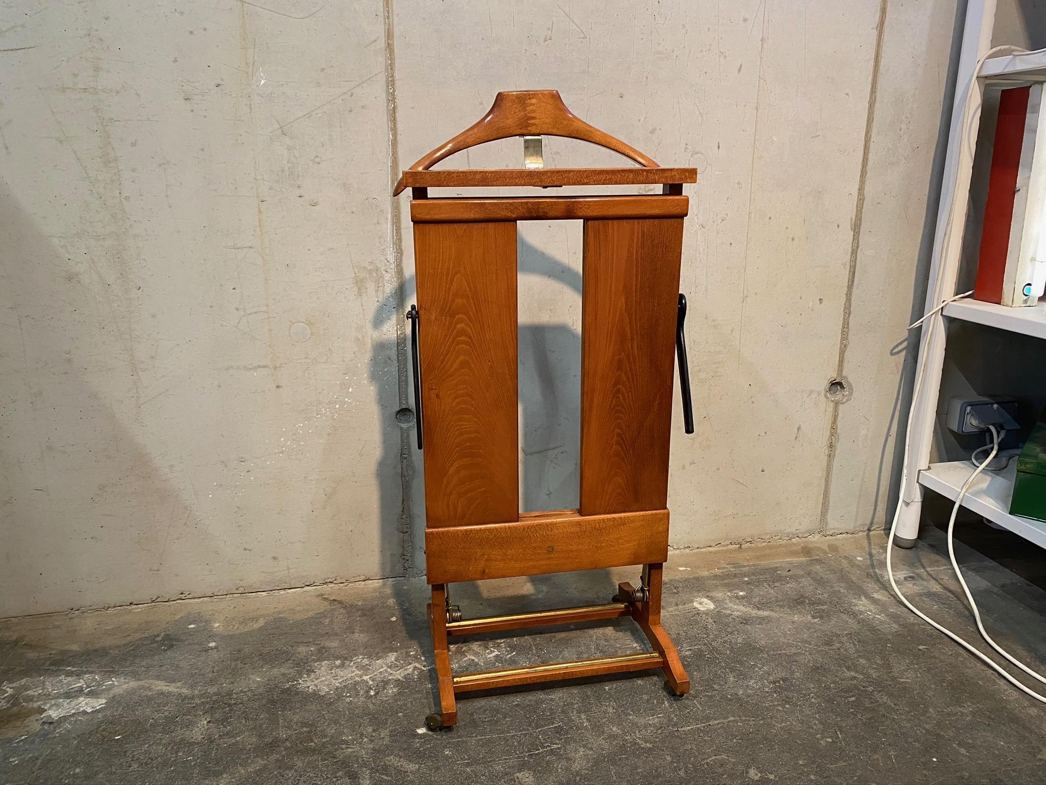 This beautiful clothes press valet out of maple and brass comes with a pants press and can hold one whole daily outfit.

Ico Parisi was an Italian architect and designer. Born Domenico Parisi in 1916 in Palermo, Italy, he was involved in building