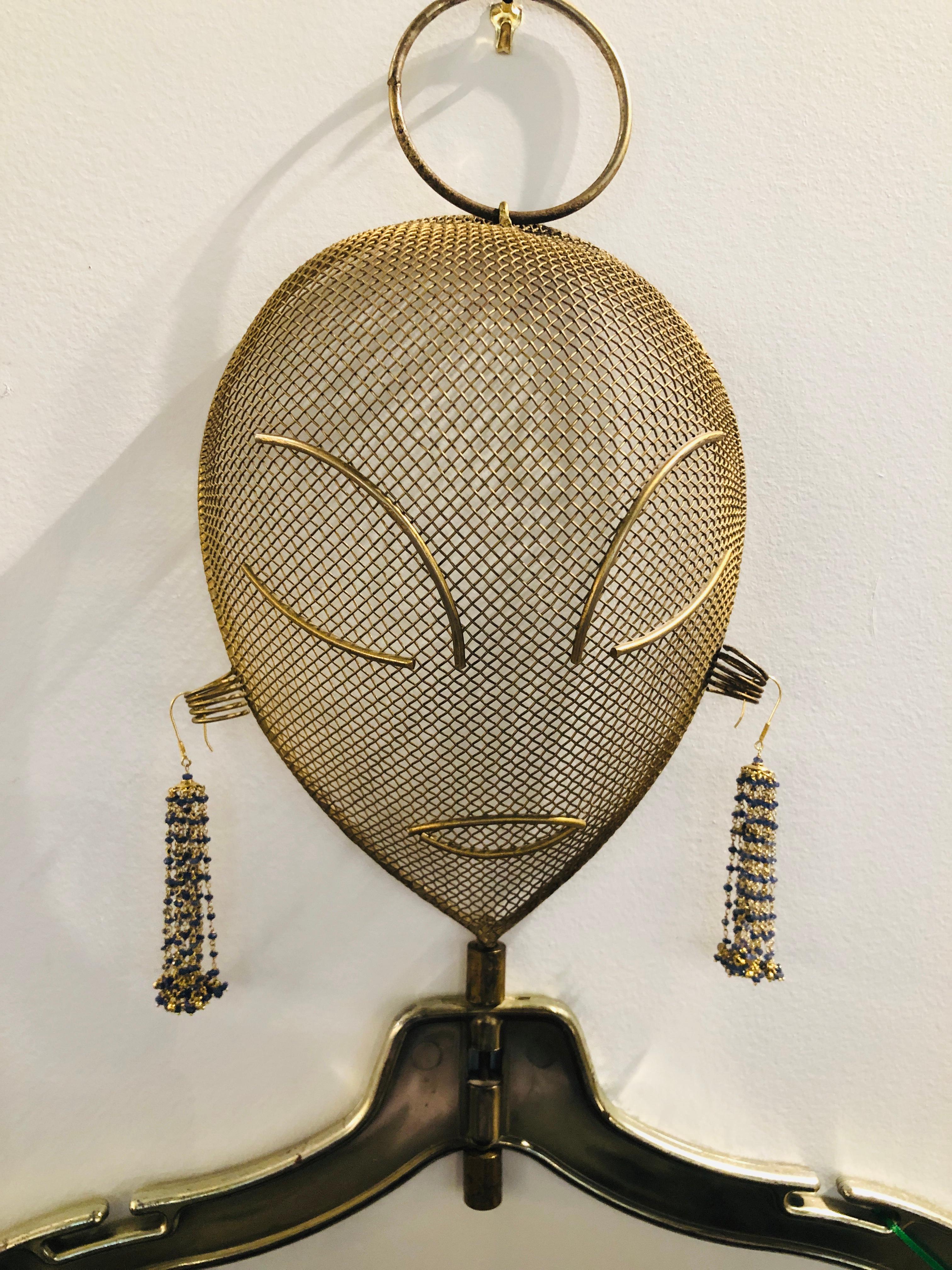 Offered is a Mid-Century Modern Frederic Weinberg bronze / gold painted metal mannequin head on hanger. The piece has a large metal loop that attaches to the crown of the head for hanging. This piece would look fabulous in a dressing room on a