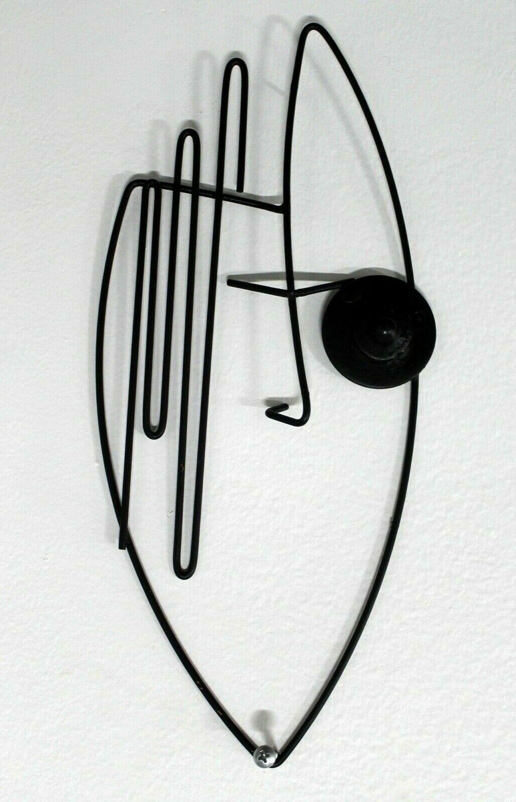 Circa the 1950's, Le Shoppe Too in Michigan brings you this amazing abstract wall sculpture by Frederick Weinberg. His classic style bends and forms wire to form abstract, stylized face. this piece makes a fantastic addition to any mid century