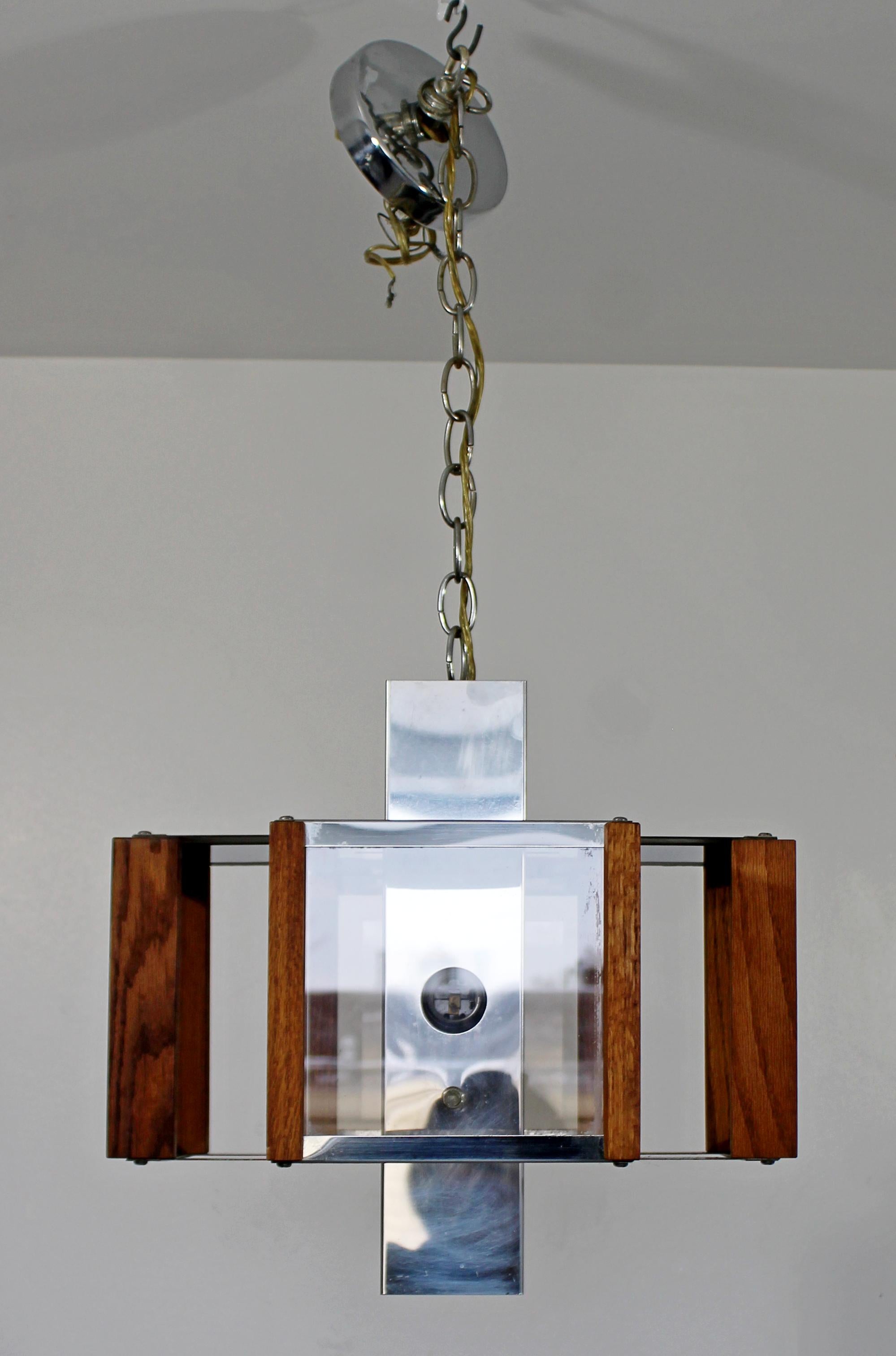 For your consideration is a simplistic, chrome and teak, windowpane style pendant light fixture or chandelier, by Fredrick Raymond, circa 1970s. In very good vintage condition. The dimensions are 15