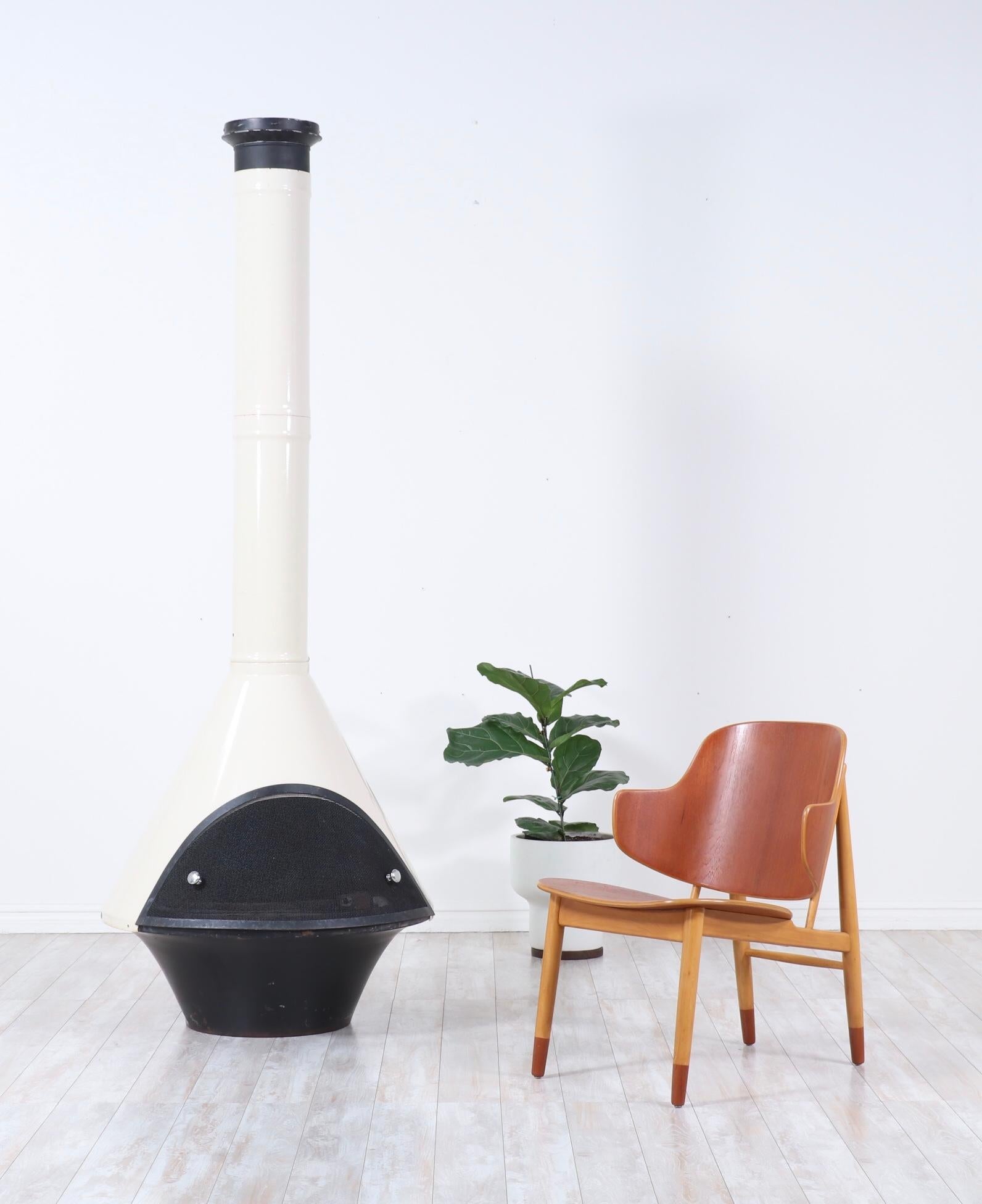Iconic, Mid-Century Modern free standing fireplace.

This fabulous fireplace is constructed of enameled steel in a ivory white and black color-way. The fire place is gas-operated and in working condition.

This fireplace would be a great