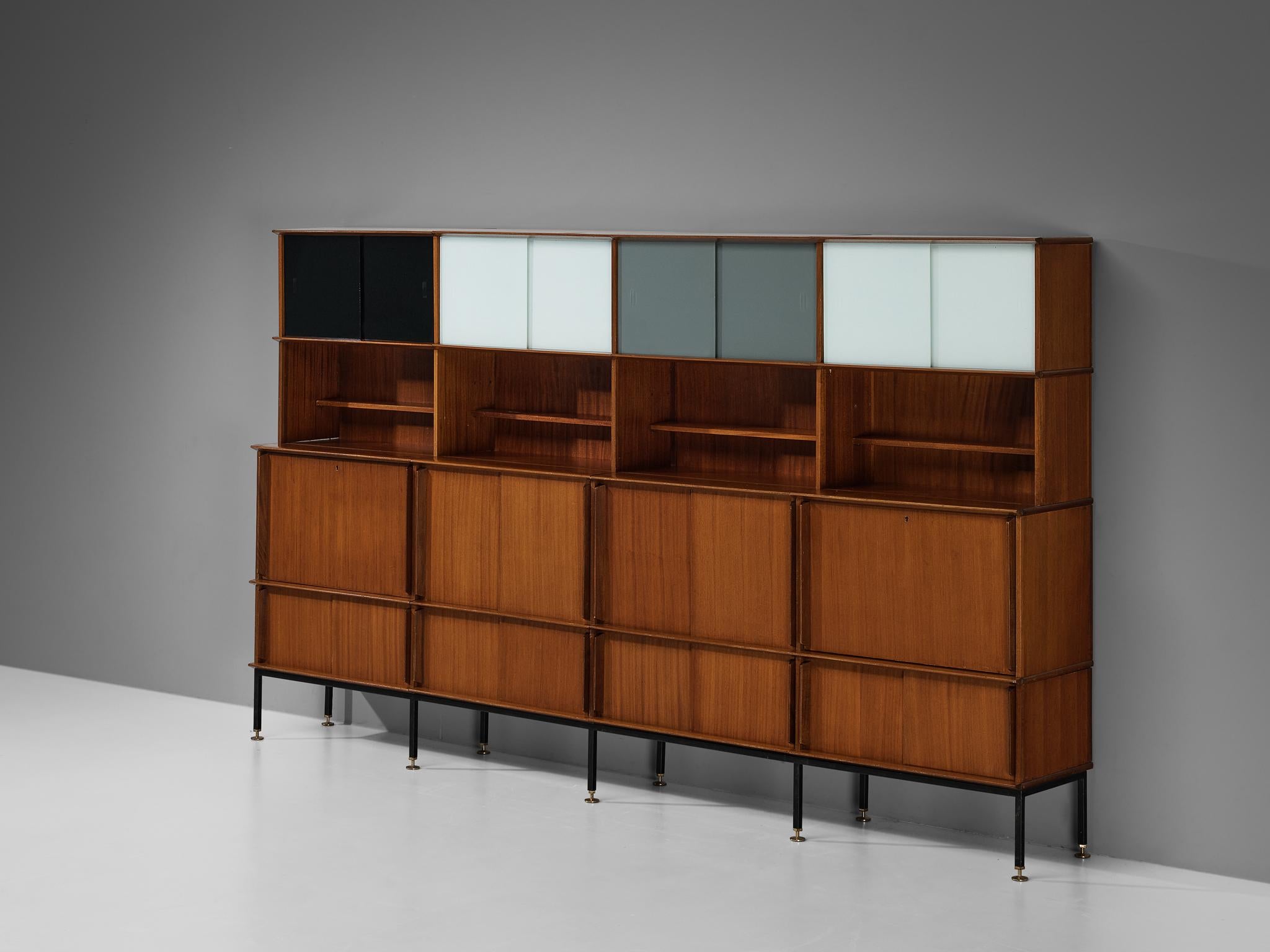 Large wall unit, mahogany, colored glass, brass, steel, France, 1950s

This delightful bookcase reflects the design principles of the Mid-Century era that rose to prominence in the 1950s and 1960s. The composition is based on four columns, each