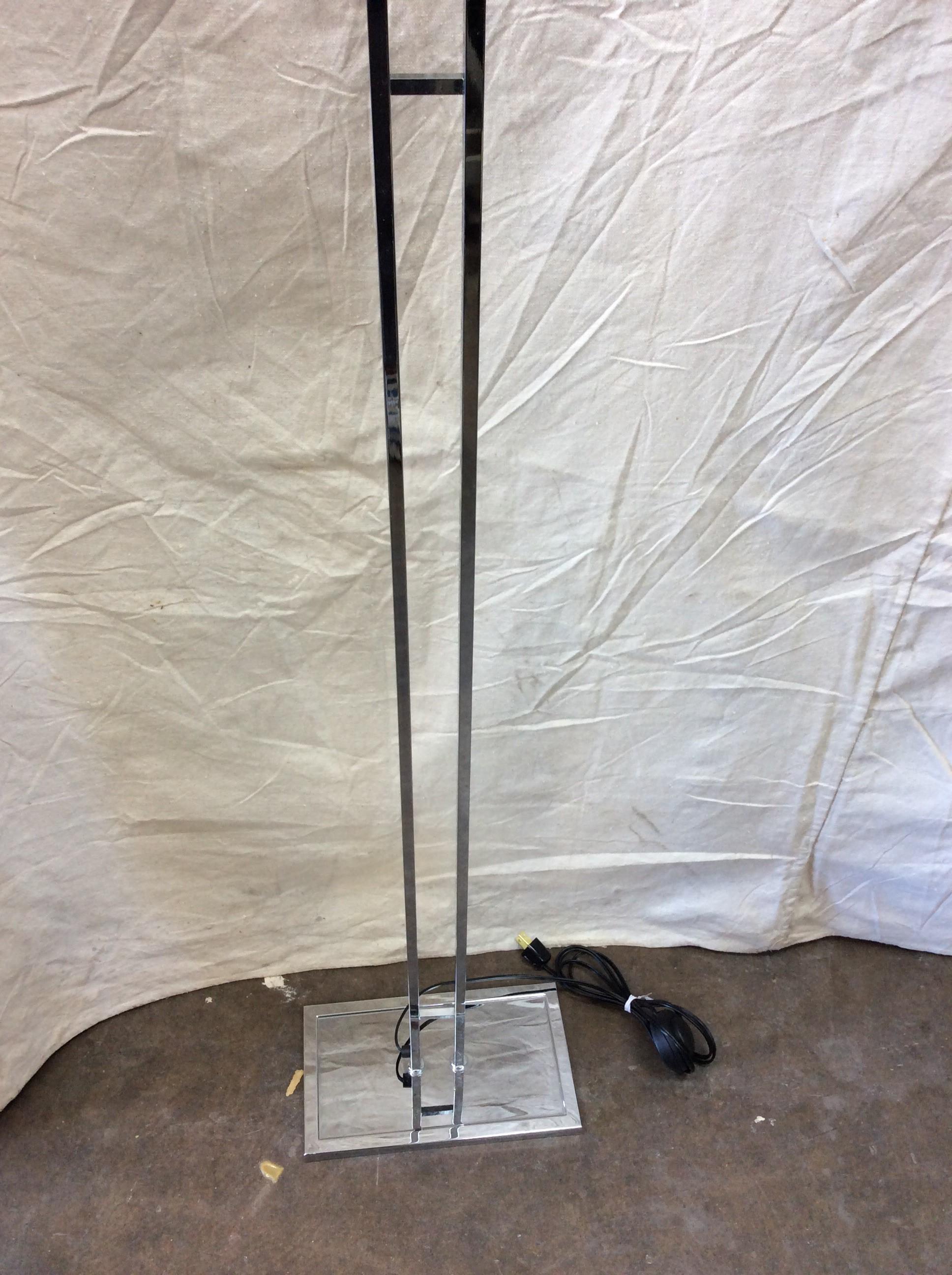 Found in the South of France, this Mid-Century Modern French Halogen Floor Lamp is constructed of metal chrome. The rectangular up light rest on two columns attached at the bottom with a rectangular metal chrome base. The floor lamp has been wired