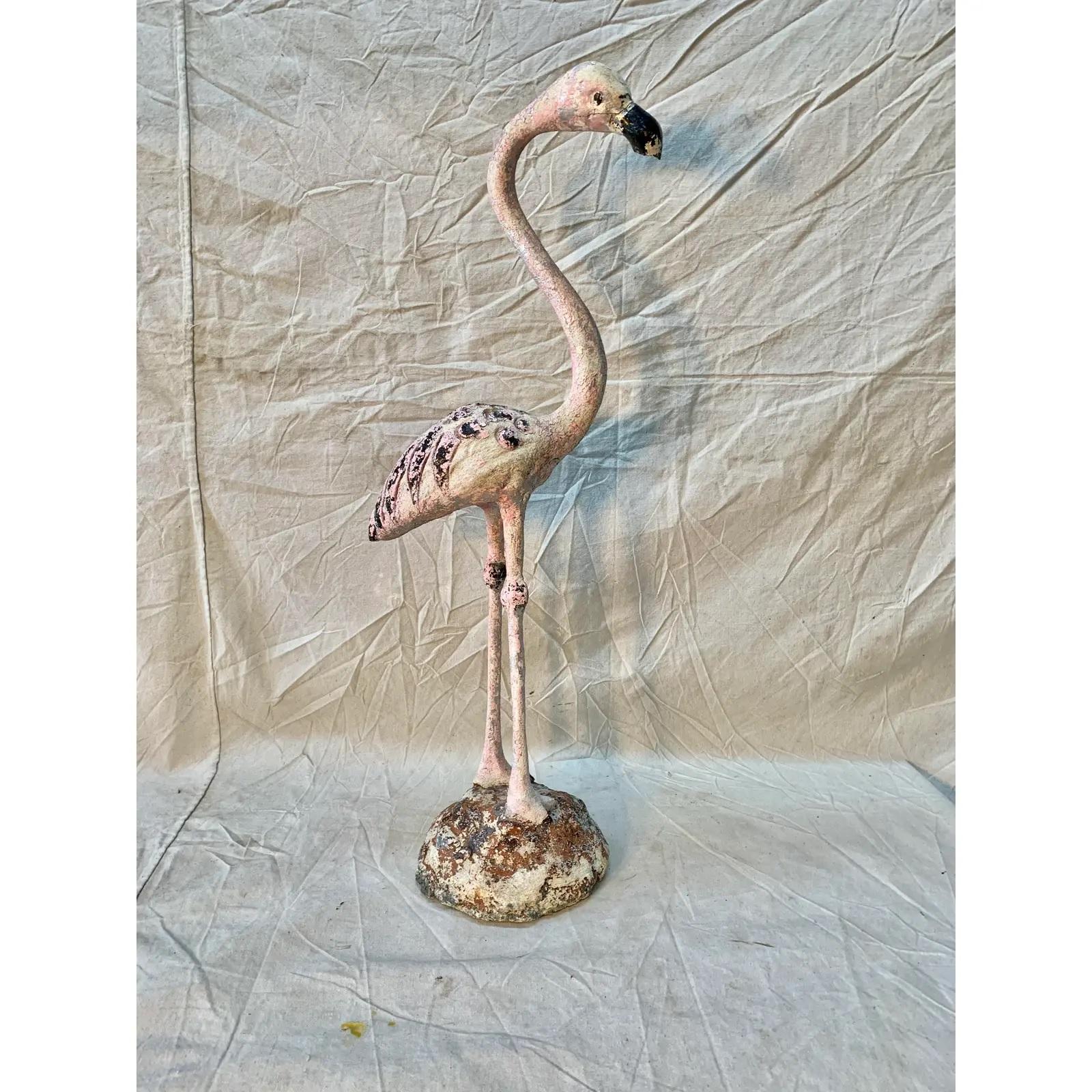 Found in the South of France, this Mid-Century Modern French Flamingo Garden Ornament is crafted entirely of cast stone concrete over an iron armature. The weathered and old, likely original, pink and black painted surface on this flamingo is
