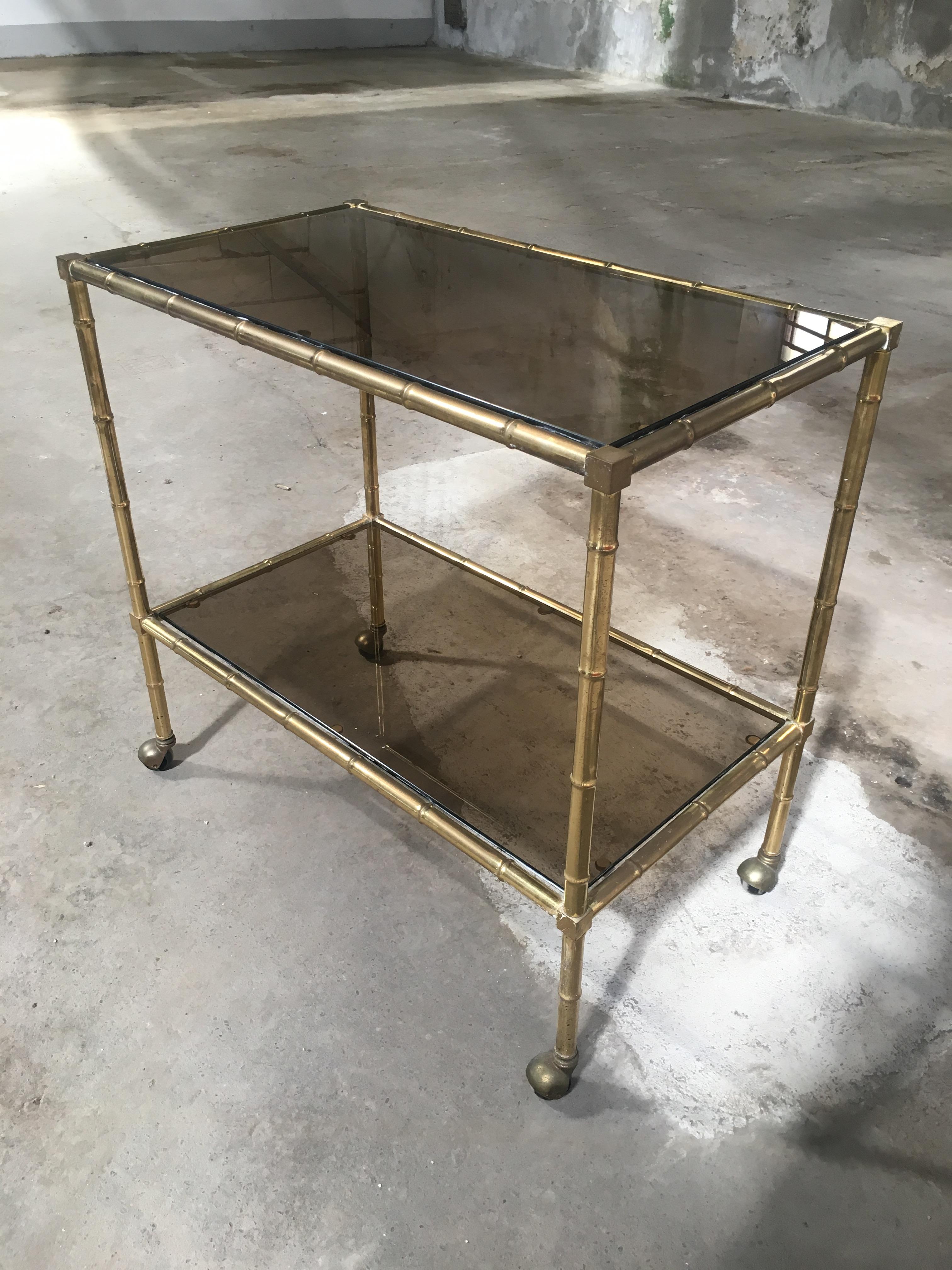Mid-Century Modern French gilt metal faux bamboo bar cart with smoked glasses by Maison Baguès.
This cart could be used as a side table and it can become a living room set together with one or two coffee tables as shown in the photos.

 