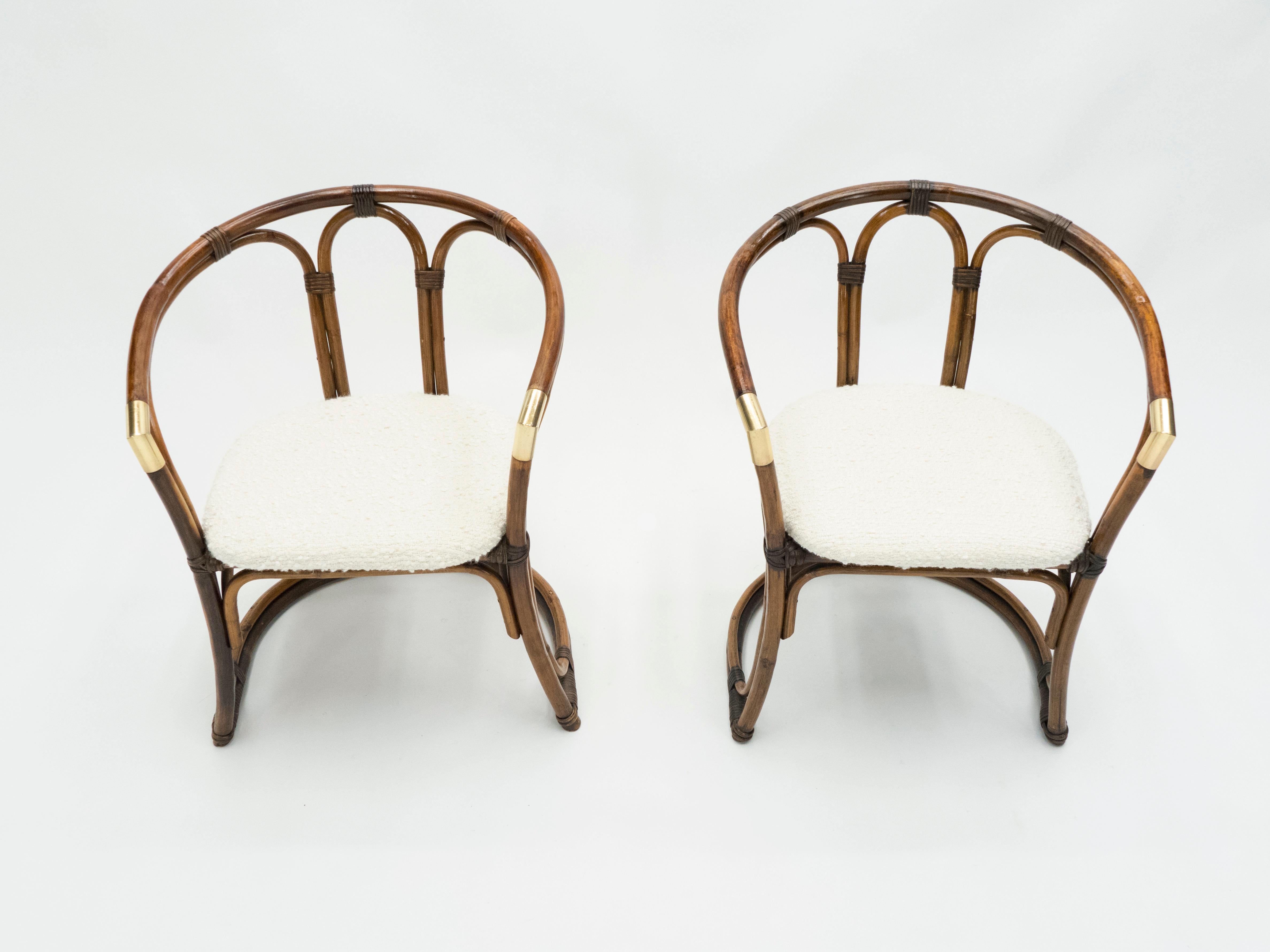 This pair of bamboo armchairs from the Mid-Century Modern French Riviera period is bursting with nostalgia. A beautiful brown bamboo structure with brass accents and bouclette wool seating would feel right at home in a stylish vacation house by the