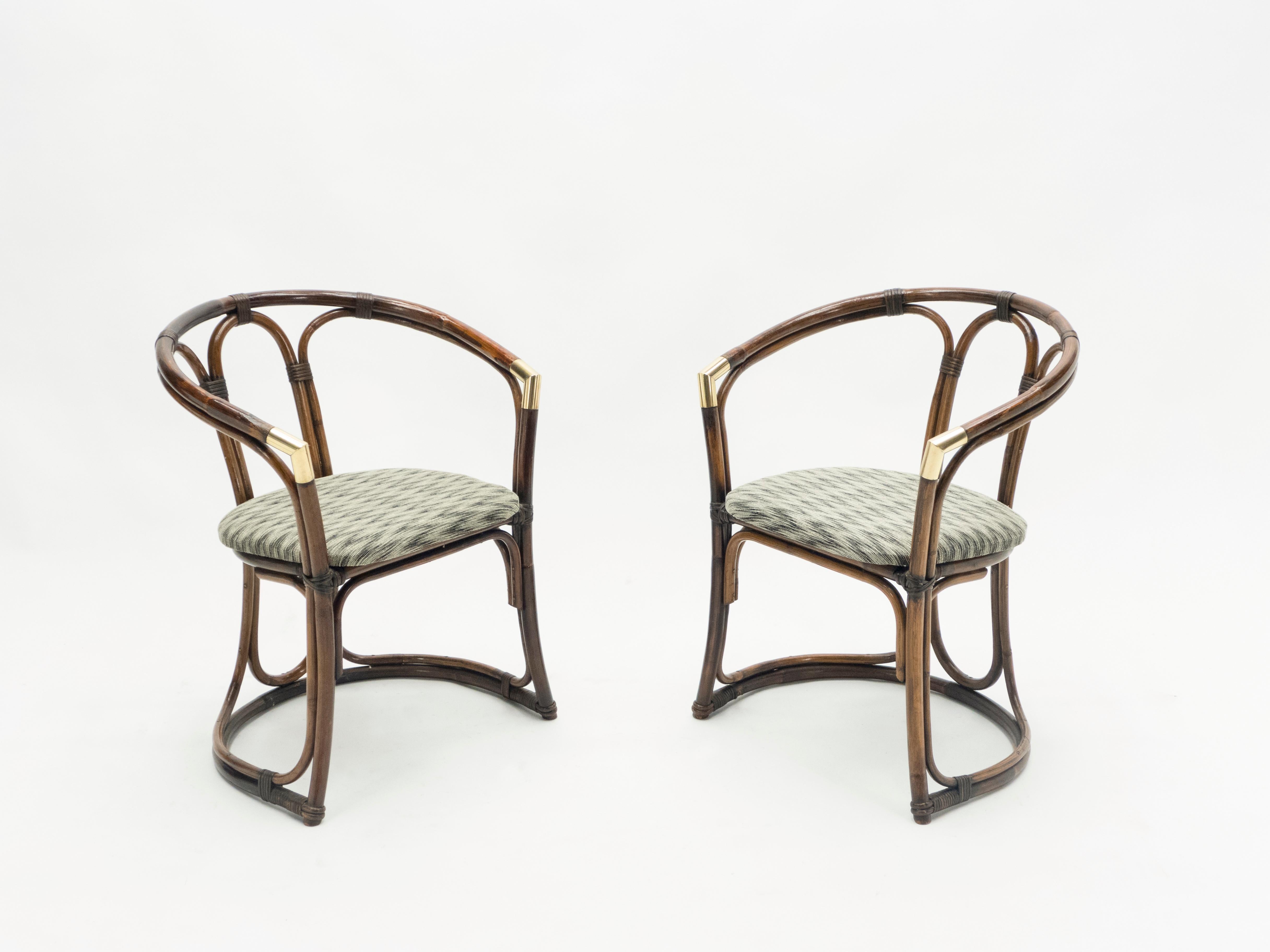This pair of bamboo armchairs from the Mid-Century Modern French Riviera period is bursting with nostalgia. A beautiful brown bamboo structure with brass accents and graphic chevron pattern seating would feel right at home in a stylish vacation