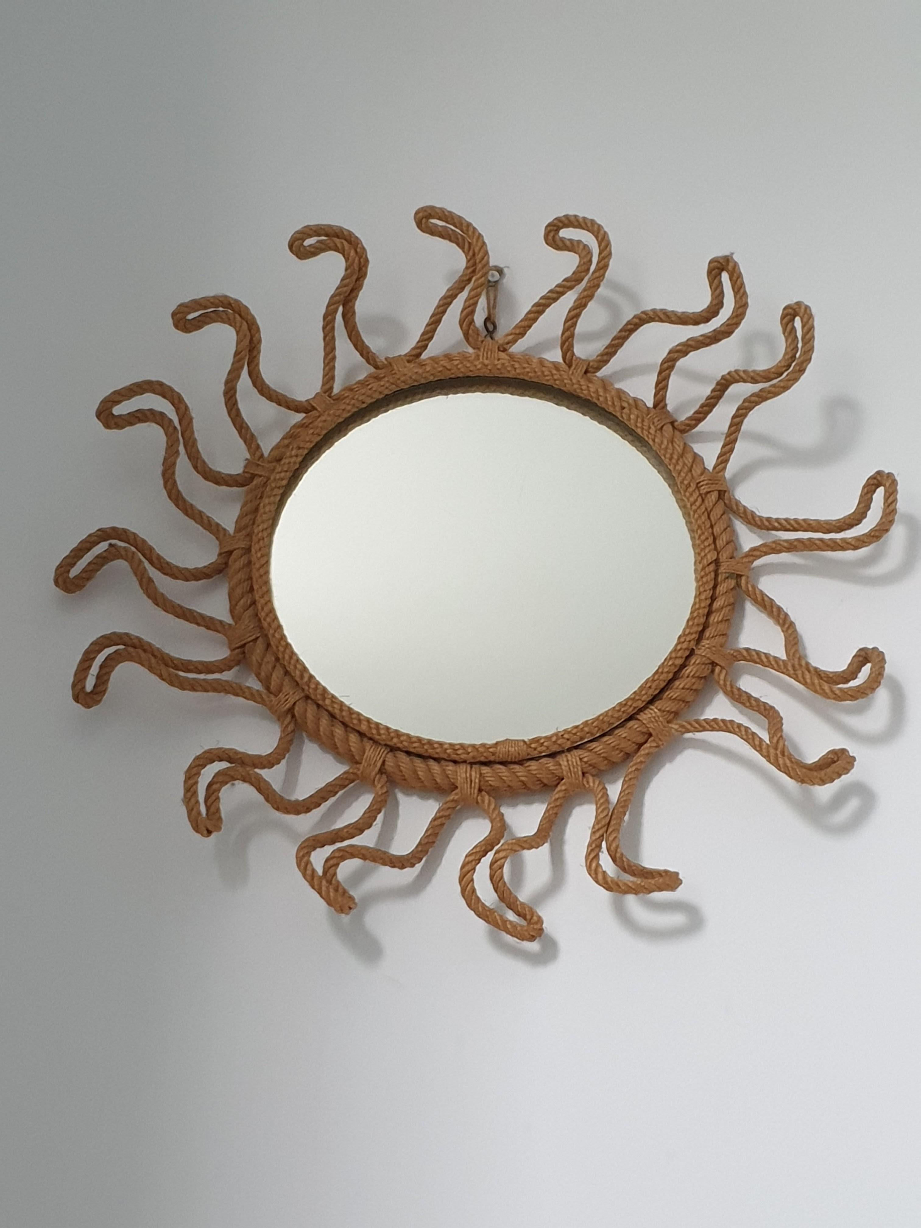 Unusual mirror made from twisted rope in the style of the classic Mirror soleil design found in the South of France. This quality mirror has a circle of rope around the plate which is then surrounded by a heavy woven rope frame, attached to which