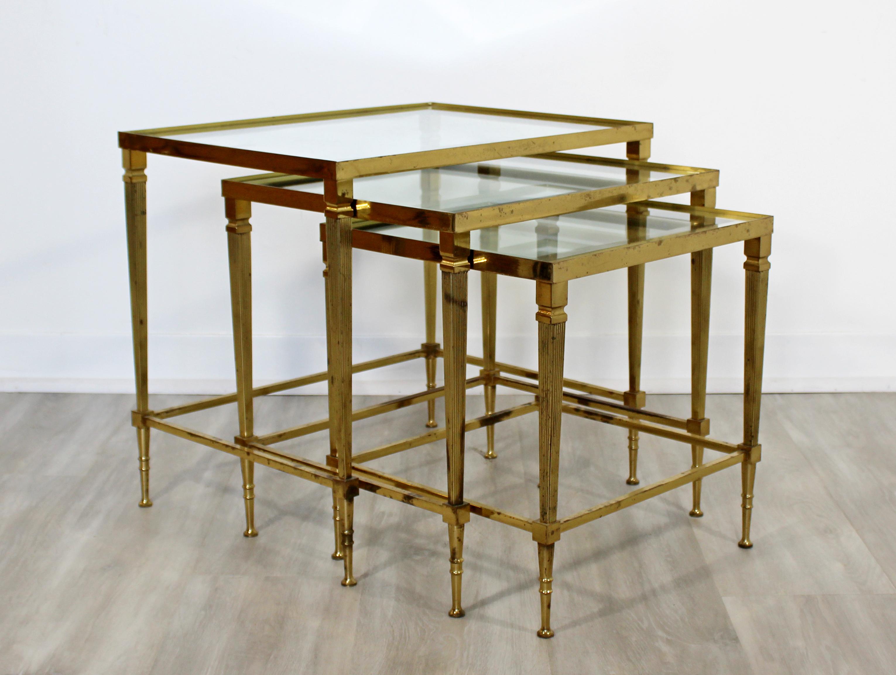 For your consideration is a fantastic set of three stacked nesting tables, made of brass and with mirrored glass inserts, circa 1950s. In good vintage condition. The dimensions of the three together are 20.25